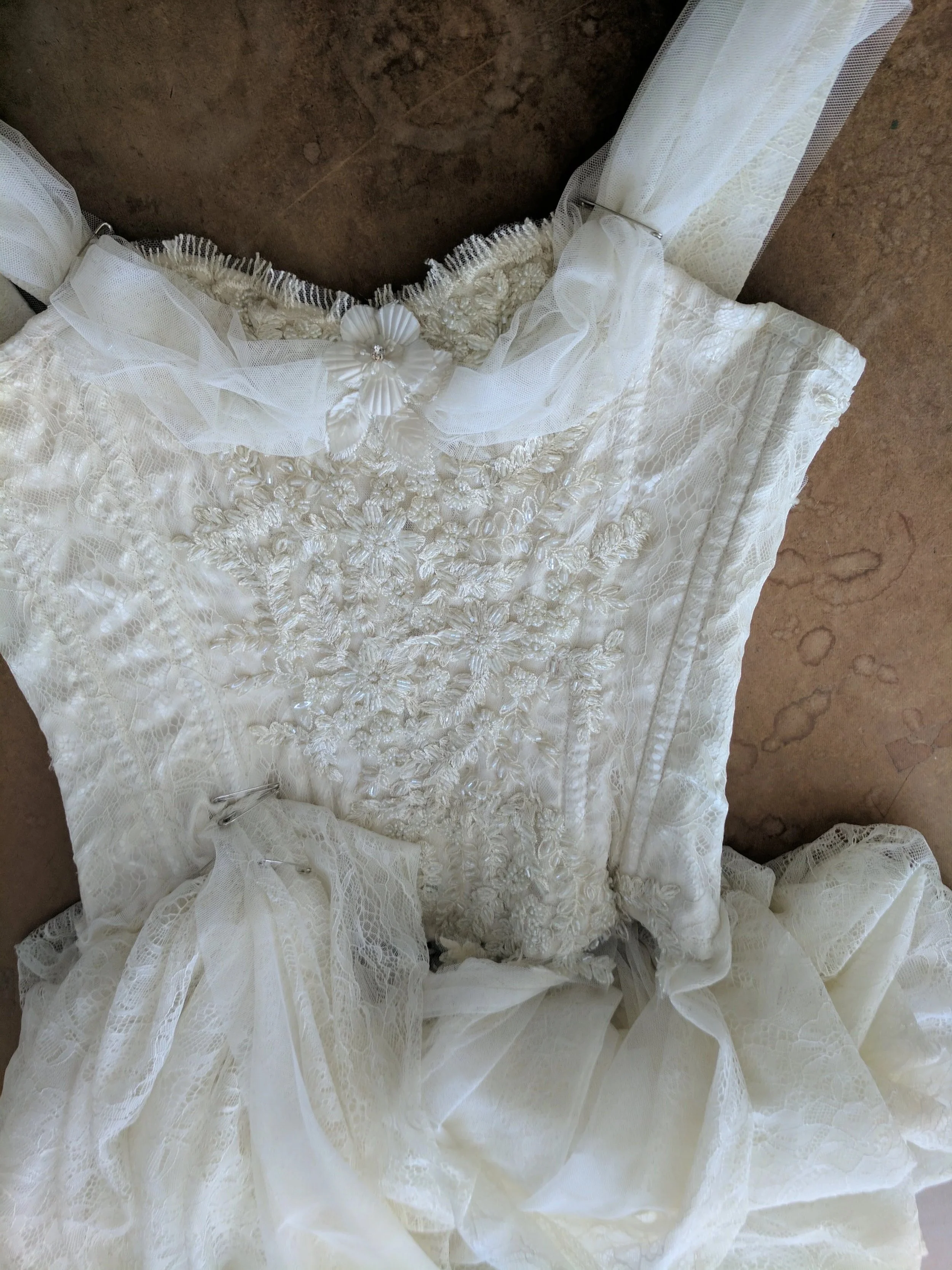Wedding dress hand beading, lace, and draping details