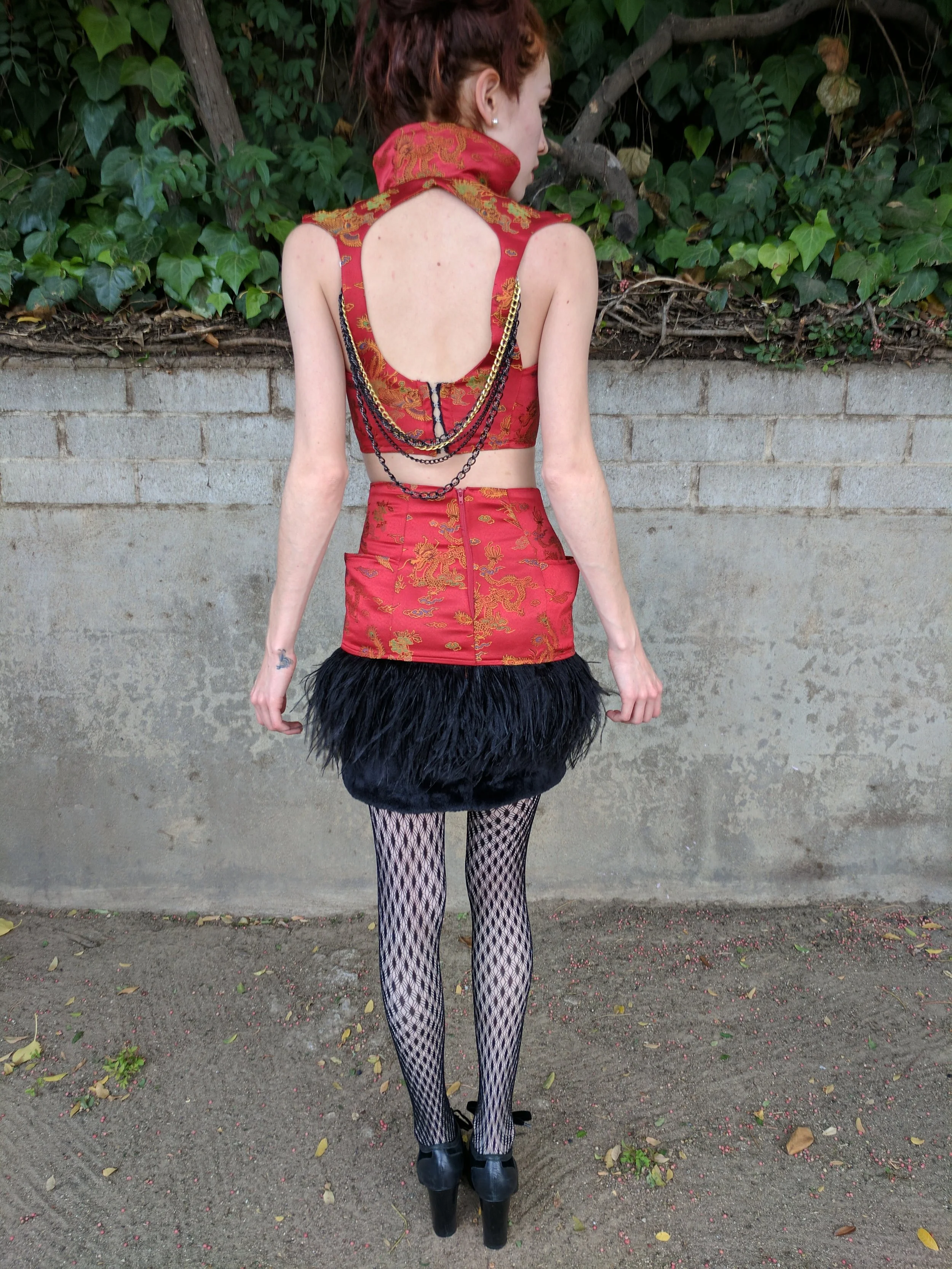 While working as an instructor at a kids school for sewing and design, we were challenged to design and create a look out of this dragon fabric and short black fur.