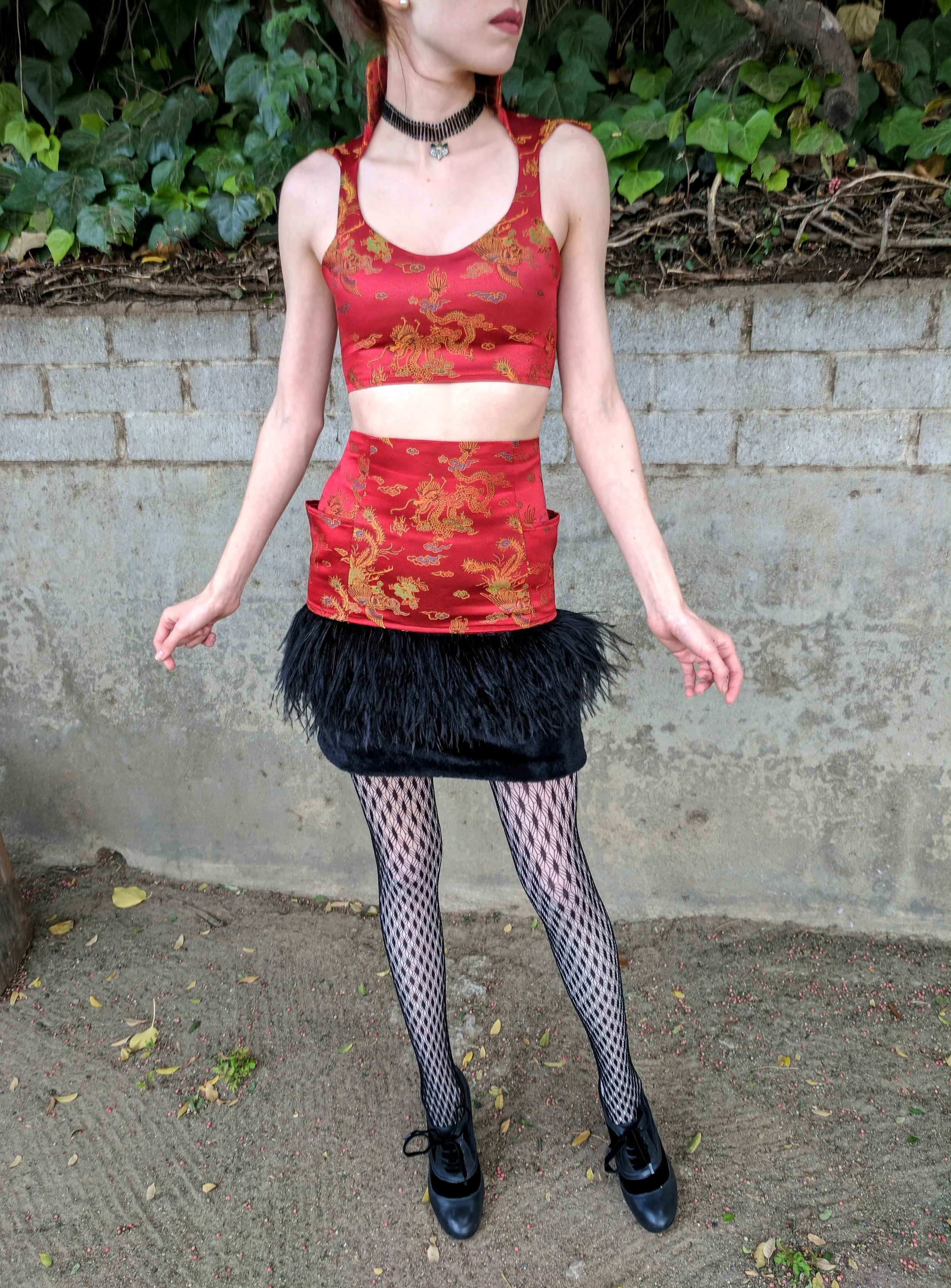 While working as an instructor at a kids school for sewing and design, we were challenged to design and create a look out of this dragon fabric and short black fur.