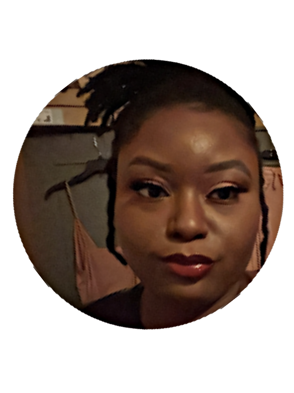 A woman with dark skin, makeup, and braided hair styled in dreadlocks, smiling for the camera.