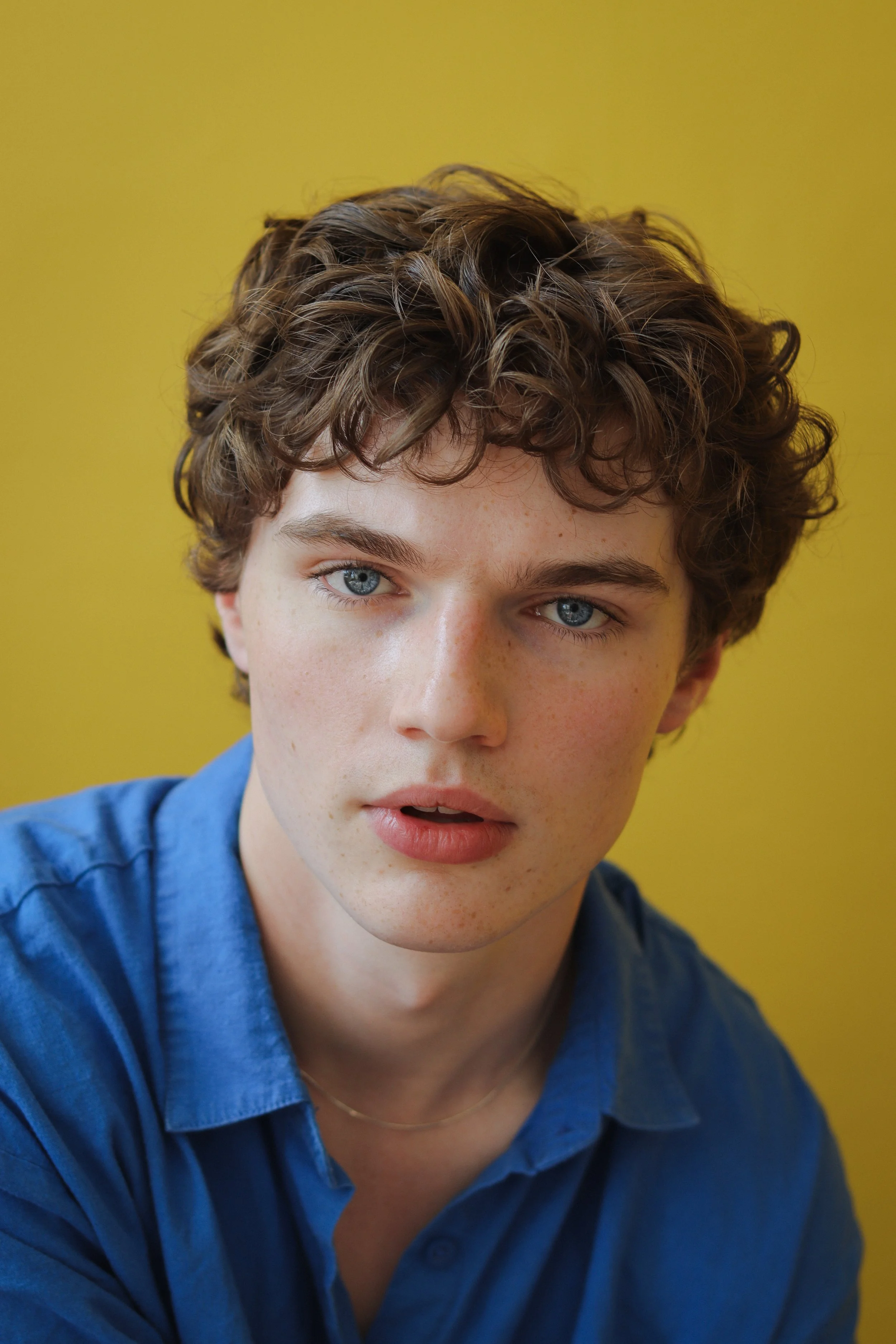 Dylan Hughes (Ludwig BBC) is a screen and stage actor from Sheffield. His actor studio headshot has a yellow background.