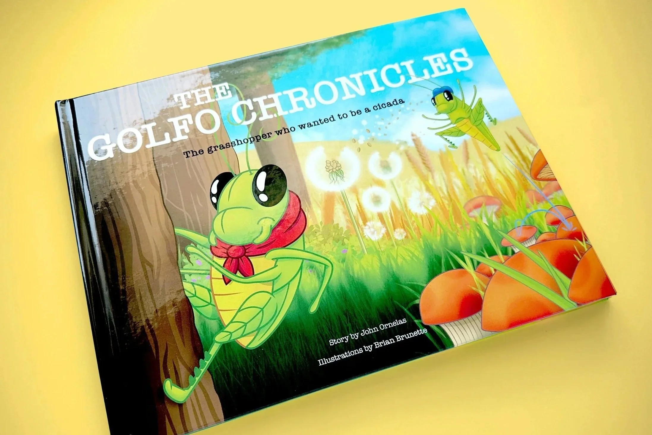 Children's book titled 'The Golfo Chronicles' with animated illustrations of two green grasshoppers in a grassy field, with a blue sky and trees in the background.