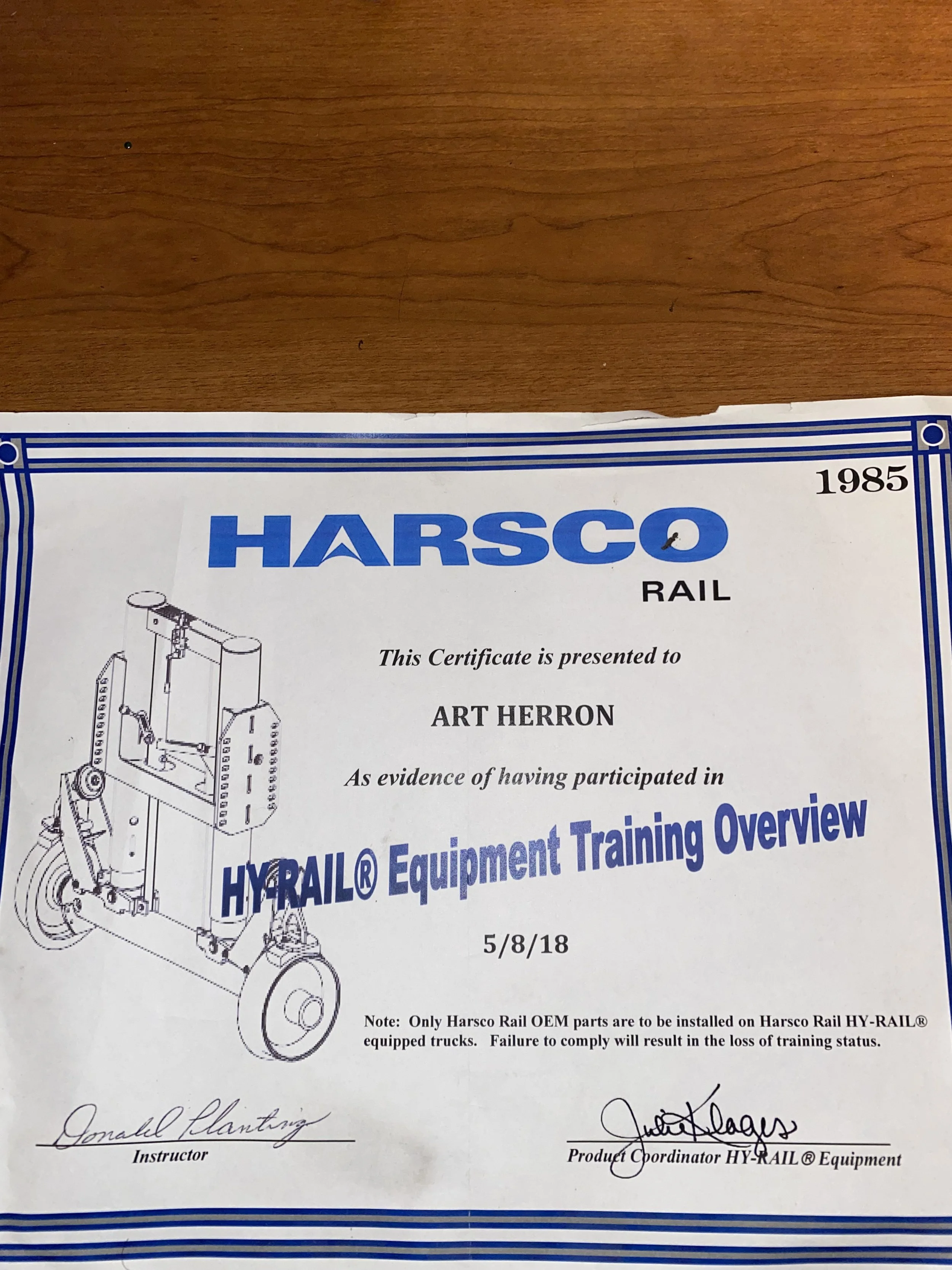 Certificate of Harsco Rail equipment training awarded to Art Herron on 5/8/18, signed by instructor Donald Plantz and product coordinator Justin Plage, with technical drawings of machinery.