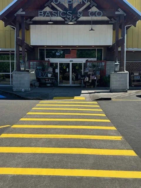 Grocery store entryway newly painted crosswalk with yellow lines
