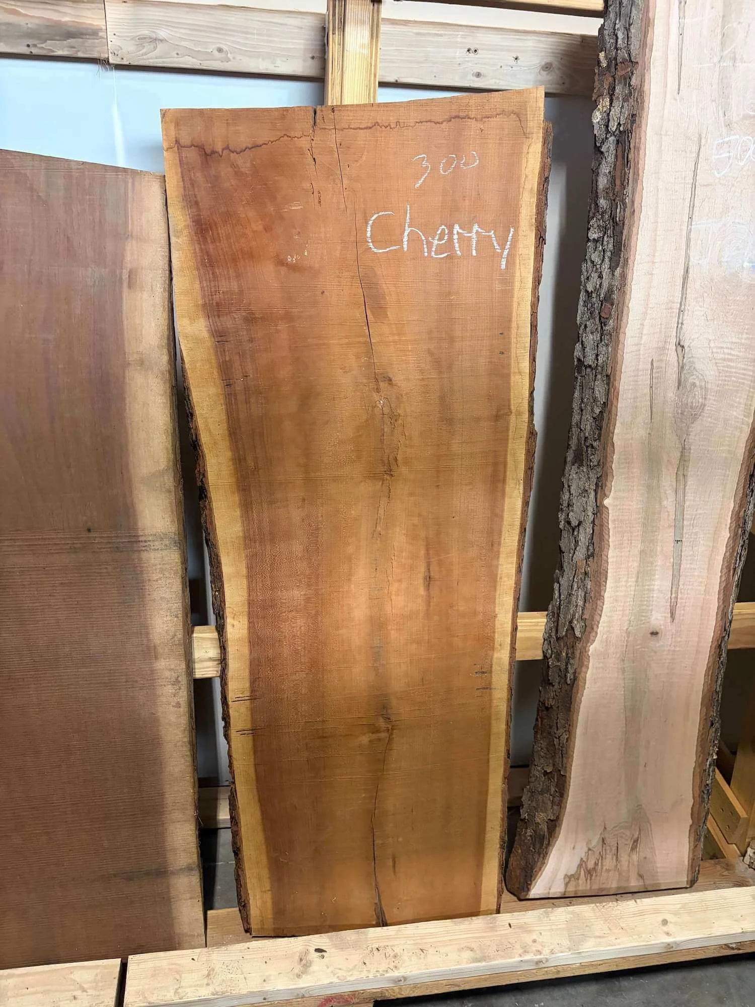 A Cherry slab displayed among other pieces of black walnut and maple hardwoods at Vermont Tree Goods.