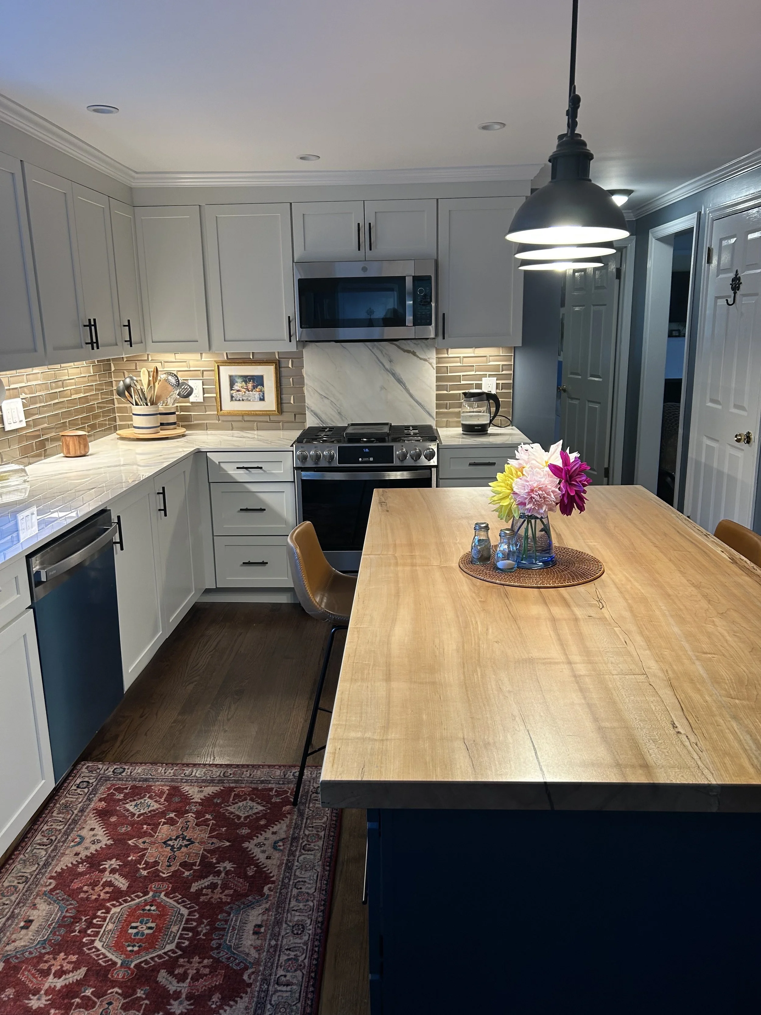 a handcrafted maple countertop with a vase of fresh flowers, recently installed in a new home