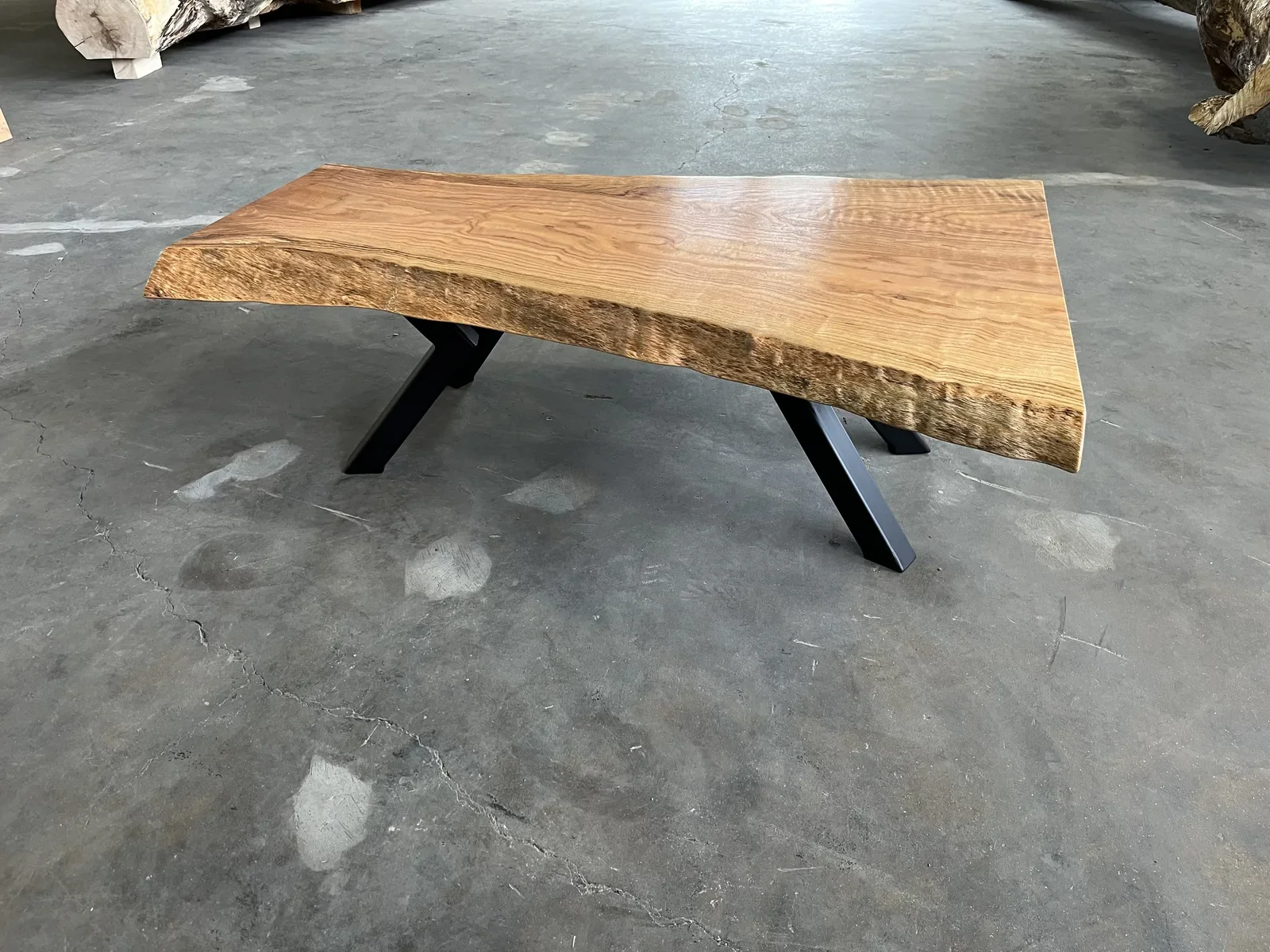 Live edge hardwood table with black A-frame metal legs, finished and ready for delivery from the Vermont Tree Goods showroom