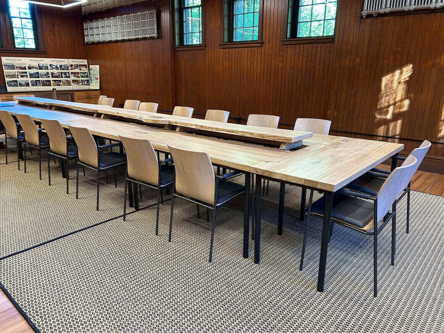 Long meeting table made out of poplar with black metal legs at the coach barn at Shelburne Farms.