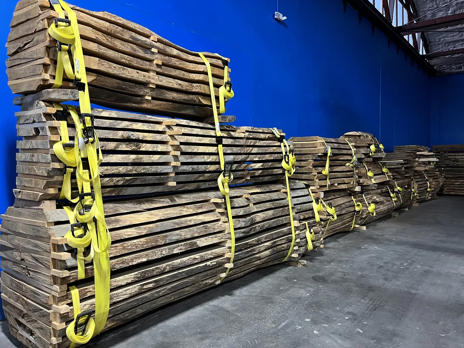 Stacks of live edge hardwood lumber stickered and bundled for air drying at Vermont Tree Goods