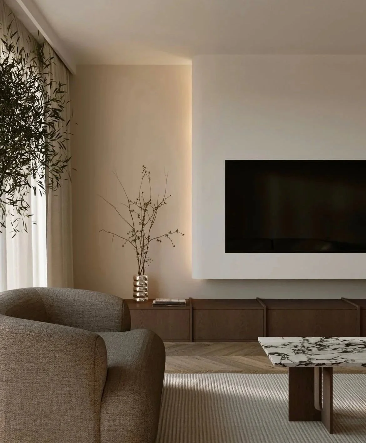 Living room with beige armchair, wooden sideboard, large wall-mounted TV, and decorative vases with minimalistic decor, natural lighting, and neutral-toned color scheme.