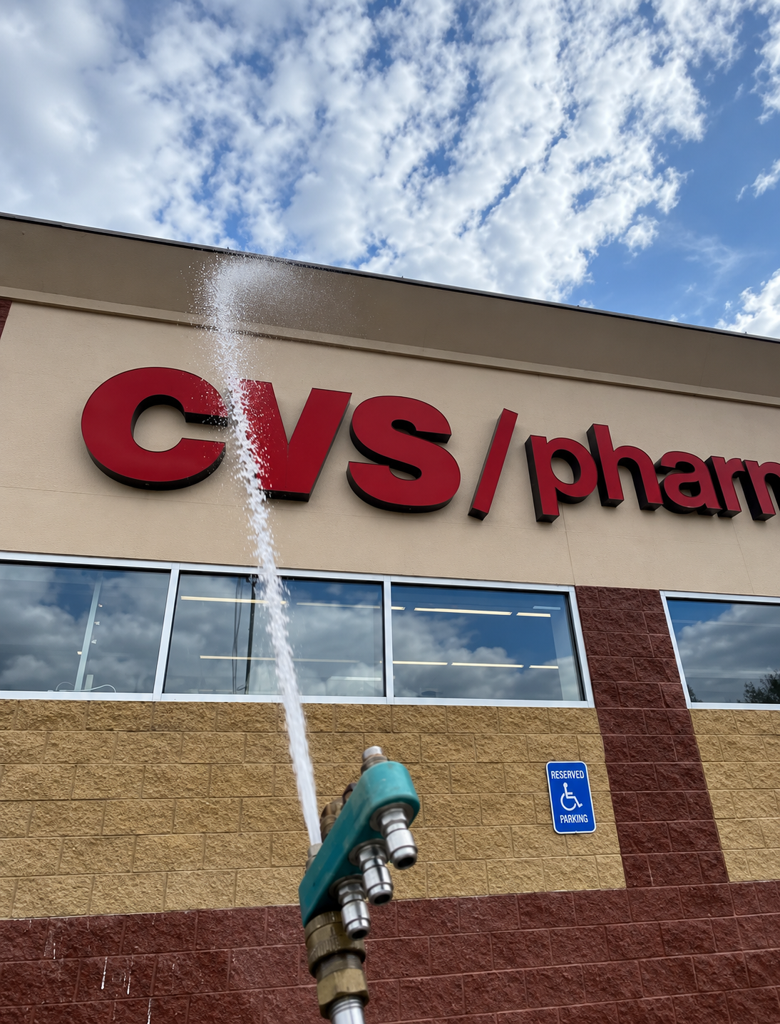 Power-Washing a CVS Pharmacy Sign