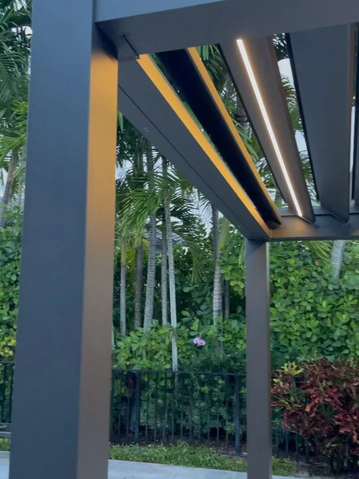 The latest pergola installation is complete. Features a sleek black aluminum finish, LED strip lights, and rotating fins.