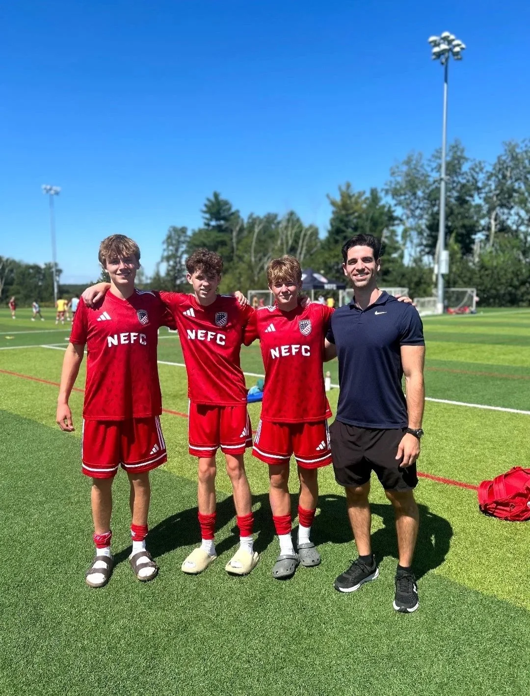 Tyler Kessler with three young athletes.