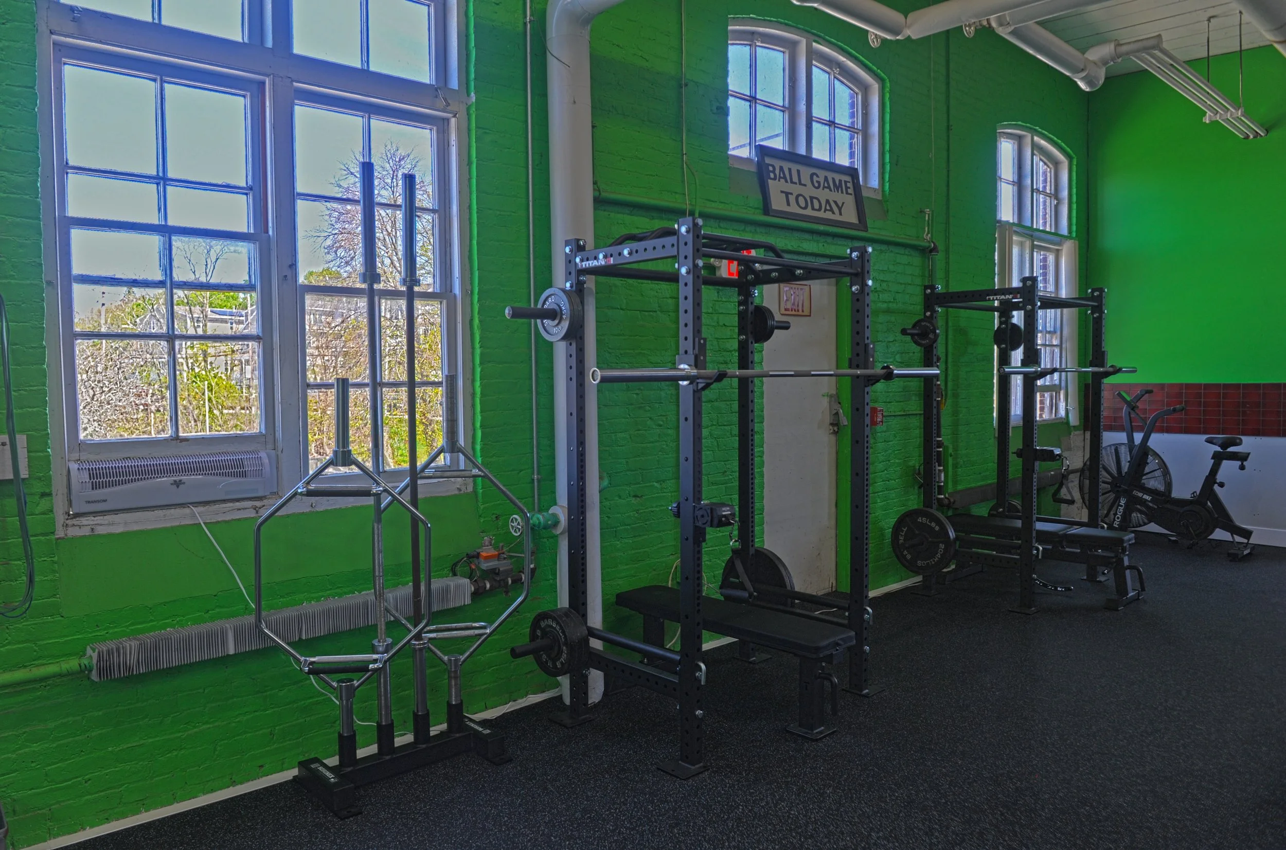 Kessler Sports Performance gym showing squat racks and stationary bike.