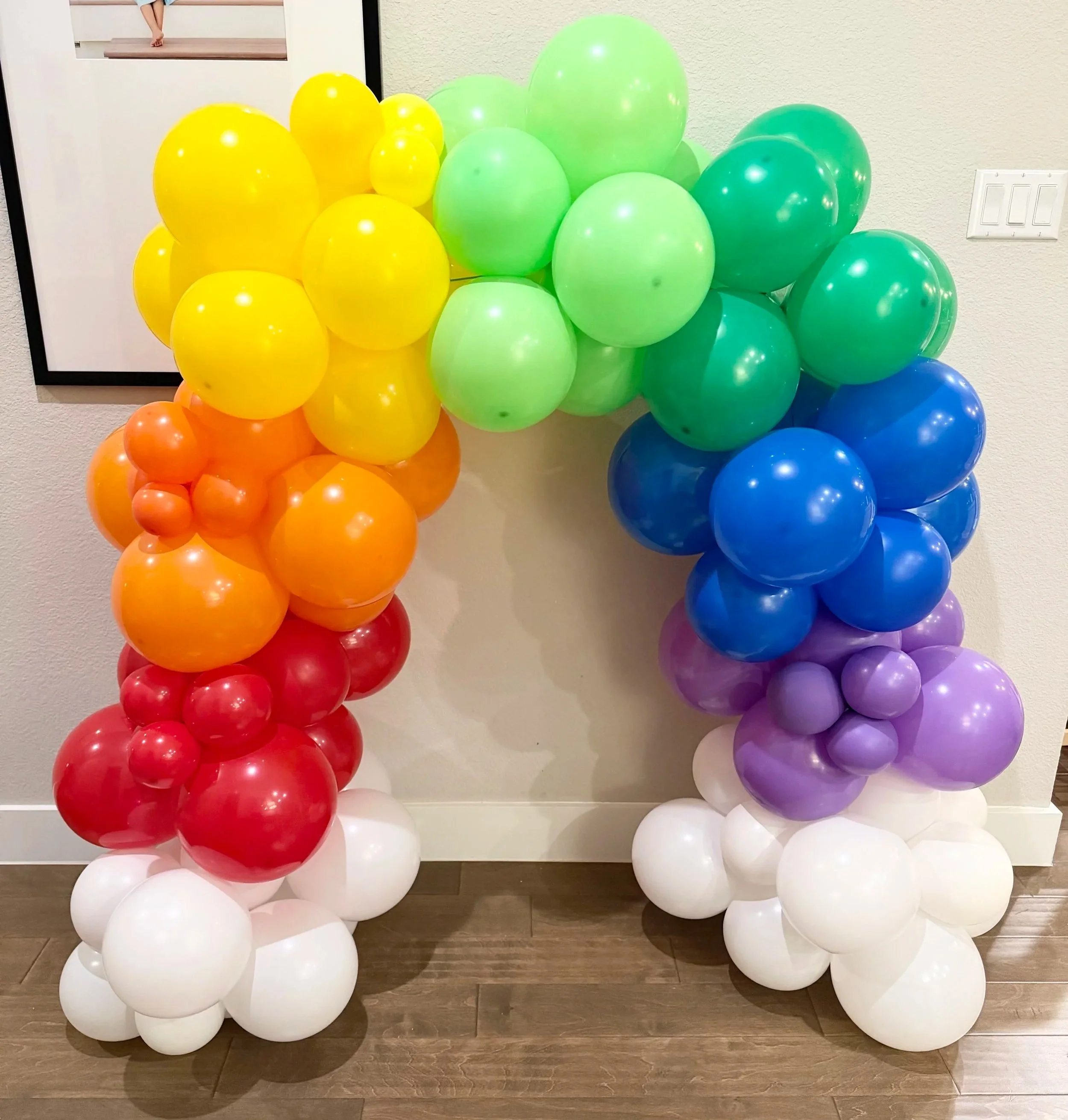 Bright rainbow balloon arch with customizable height created by Dripping springs based ColorPop Balloon Studio.