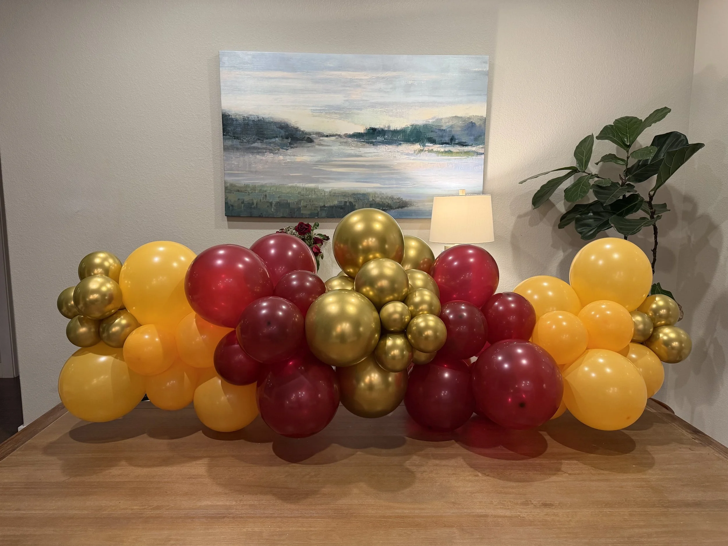 Maroon, orange and gold fall inspired balloon garland perfect for personal or corporate events, created by Dripping springs based ColorPop Balloon Studio.