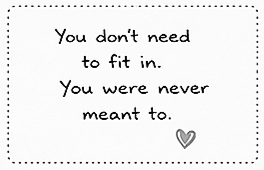 A framed quote that says 'You don't need to fit in. You were never meant to.' with a small heart illustration at the bottom right corner.