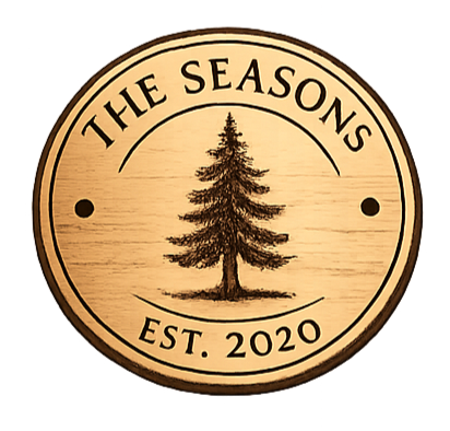 Wooden circular sign with a pine tree illustration, text 'The Seasons,' and 'Est. 2020'.