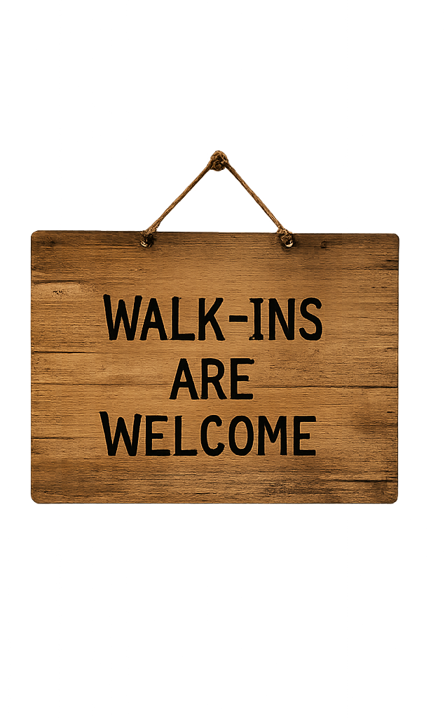 A wooden sign hanging from a string reads, 'Walk-ins are welcome.'