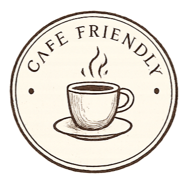 Coffee cup with steam on a saucer, surrounded by text that reads "Cafe Friendly" in a circular design.