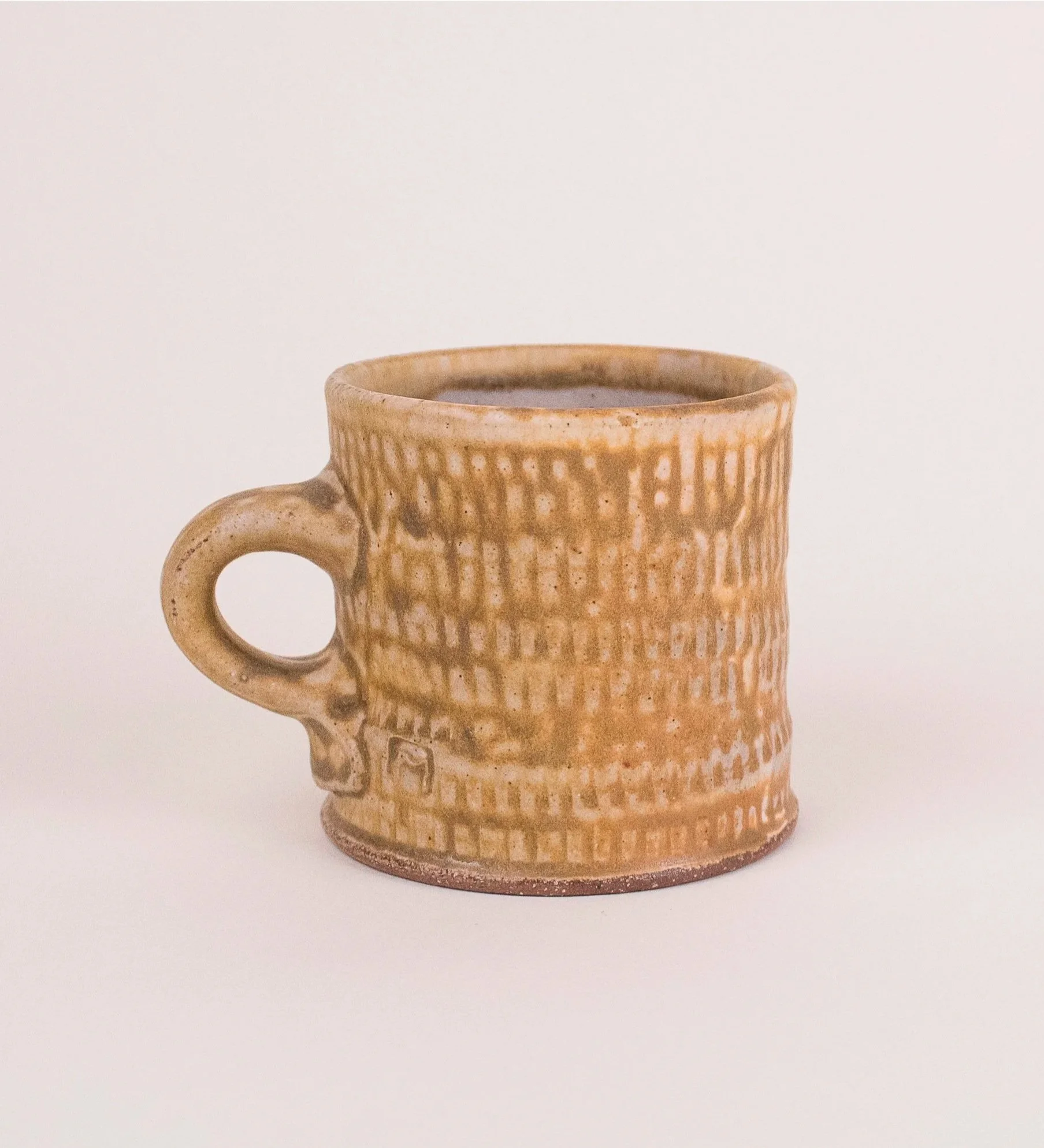 Textured mug #1, stoneware, ash glaze, salt-fired, (4 x 4 x 4 in), 2023.)