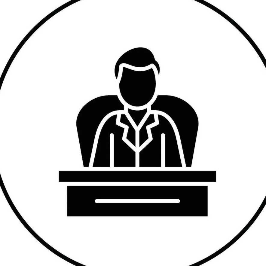 Icon of a person sitting behind a desk, representing a business professional or executive.