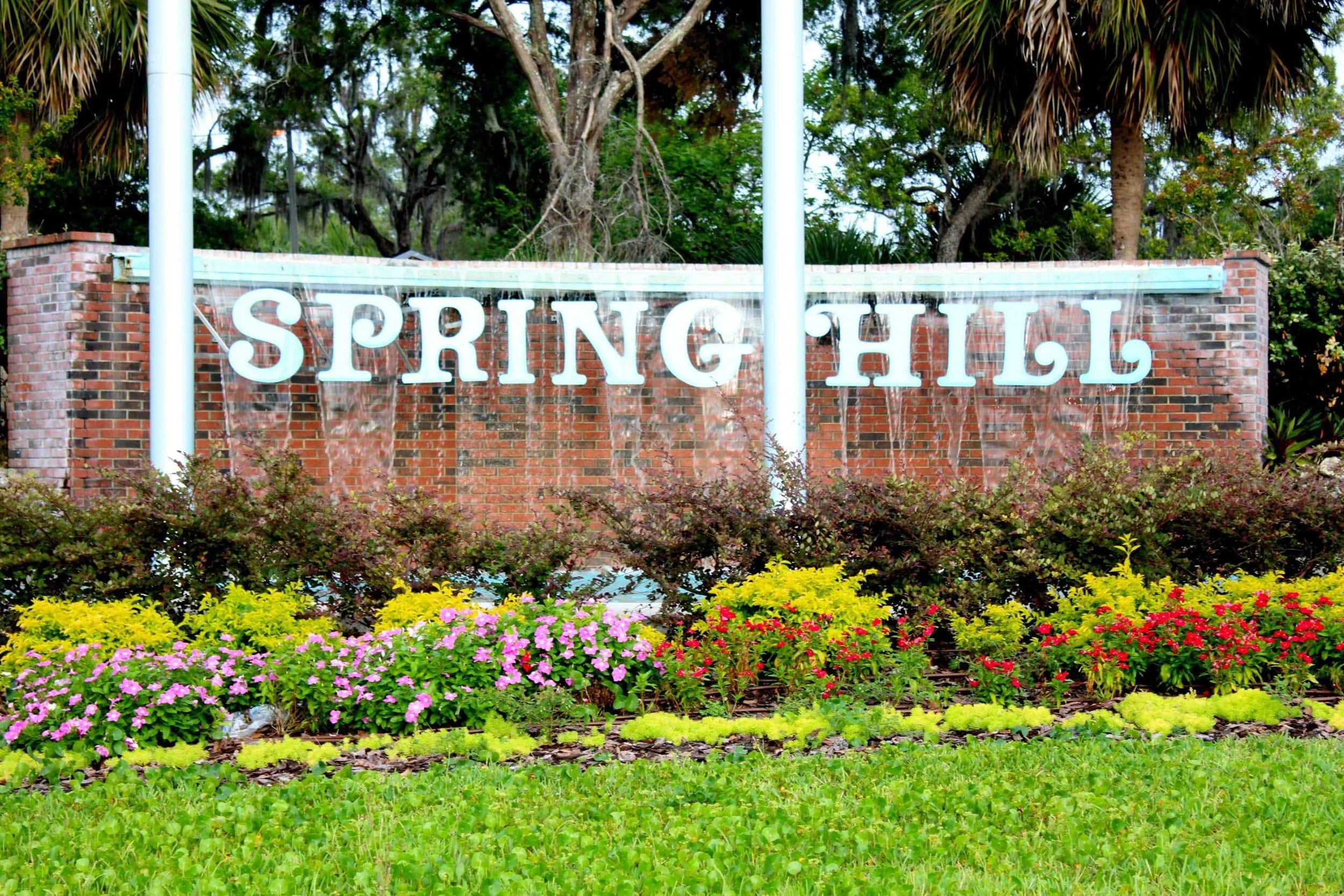 Spring Hill Florida entrance sign and landscaped flowers