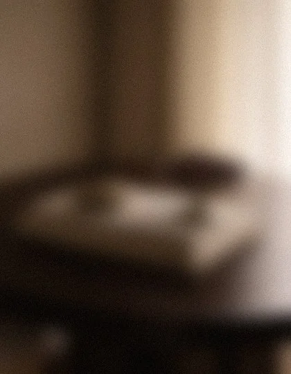A blurry image of a stove with a gas burner and a countertop.