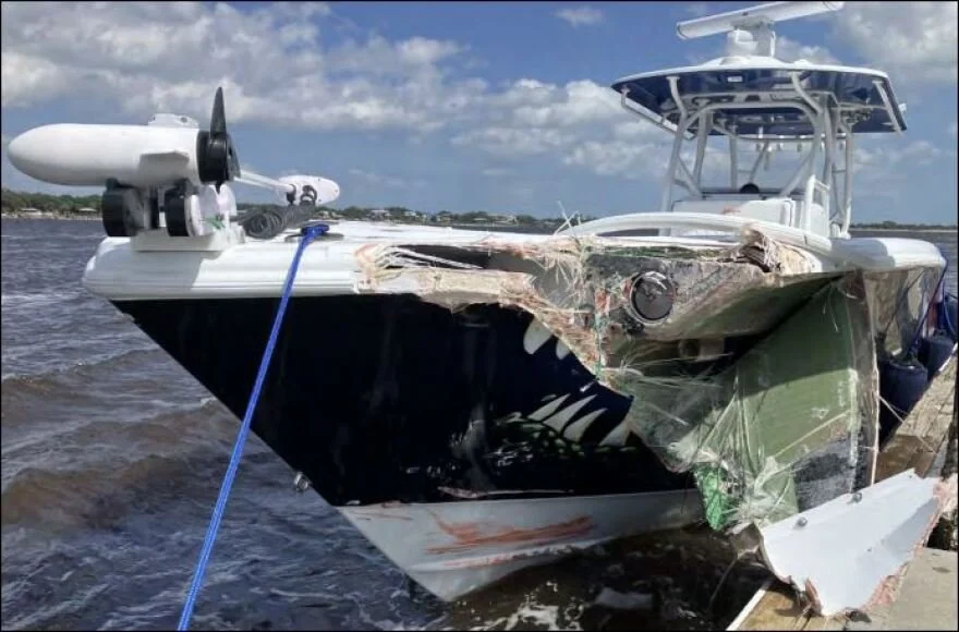 A damaged boat with a large hole and scratches on its side is the results of a marine accident and in need of a marine investigation and expert witness.