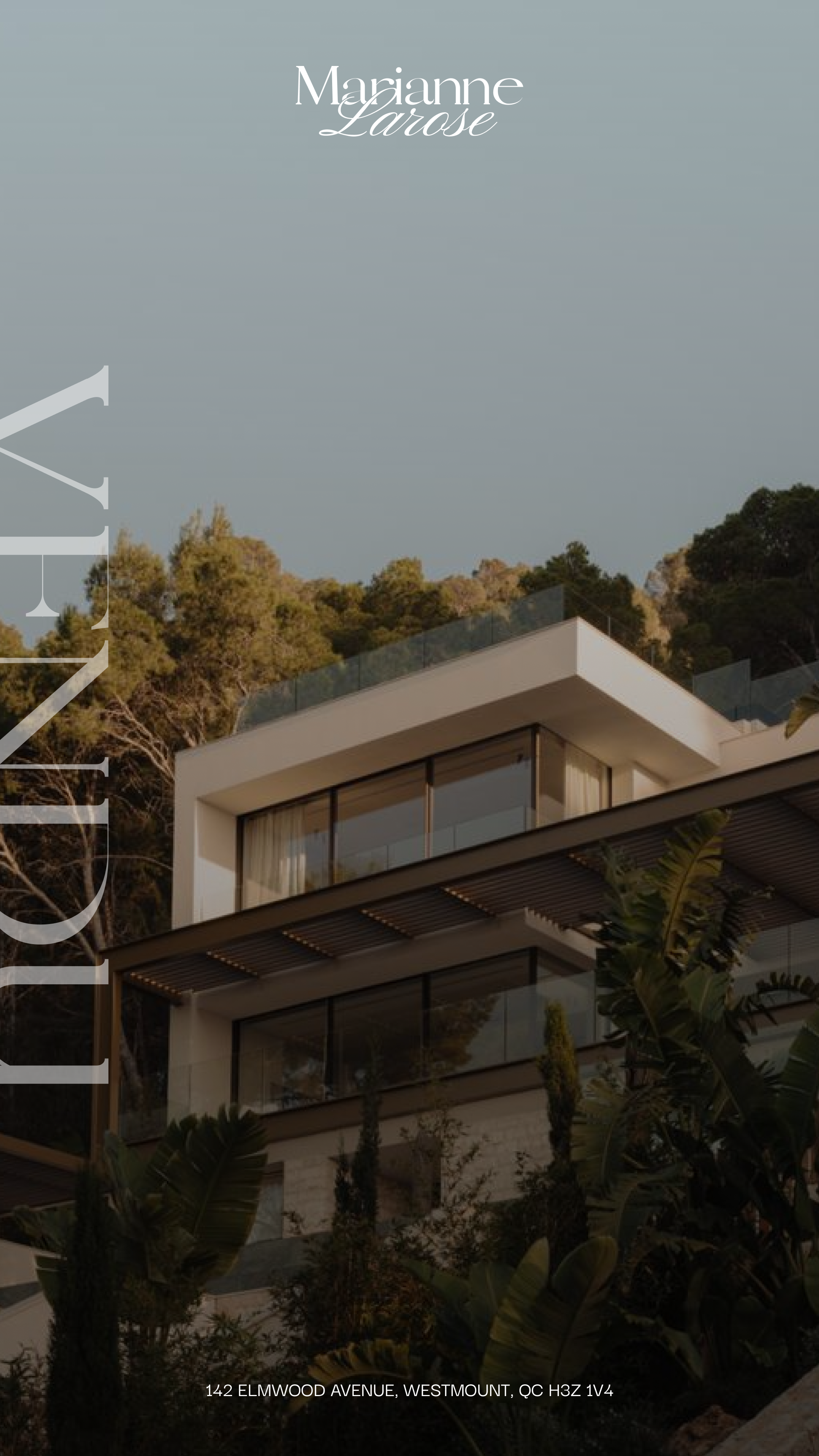 Modern multi-story house with large glass windows and balconies, set on a hillside with trees, located at 142 Elmwood Avenue, Westmount, QC.