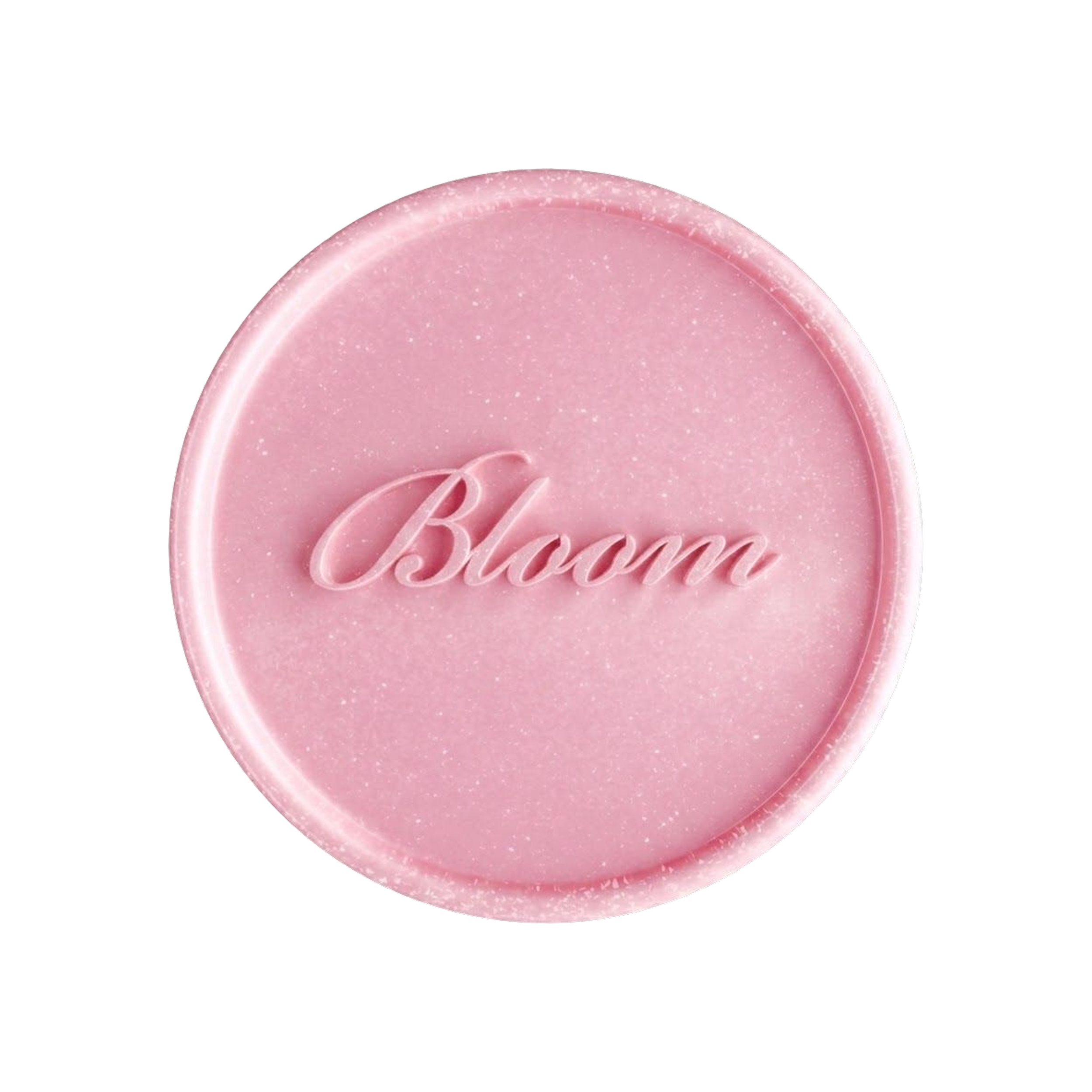 Close-up of a pink circular candle with a faint embossed script in the center, against a black background.
