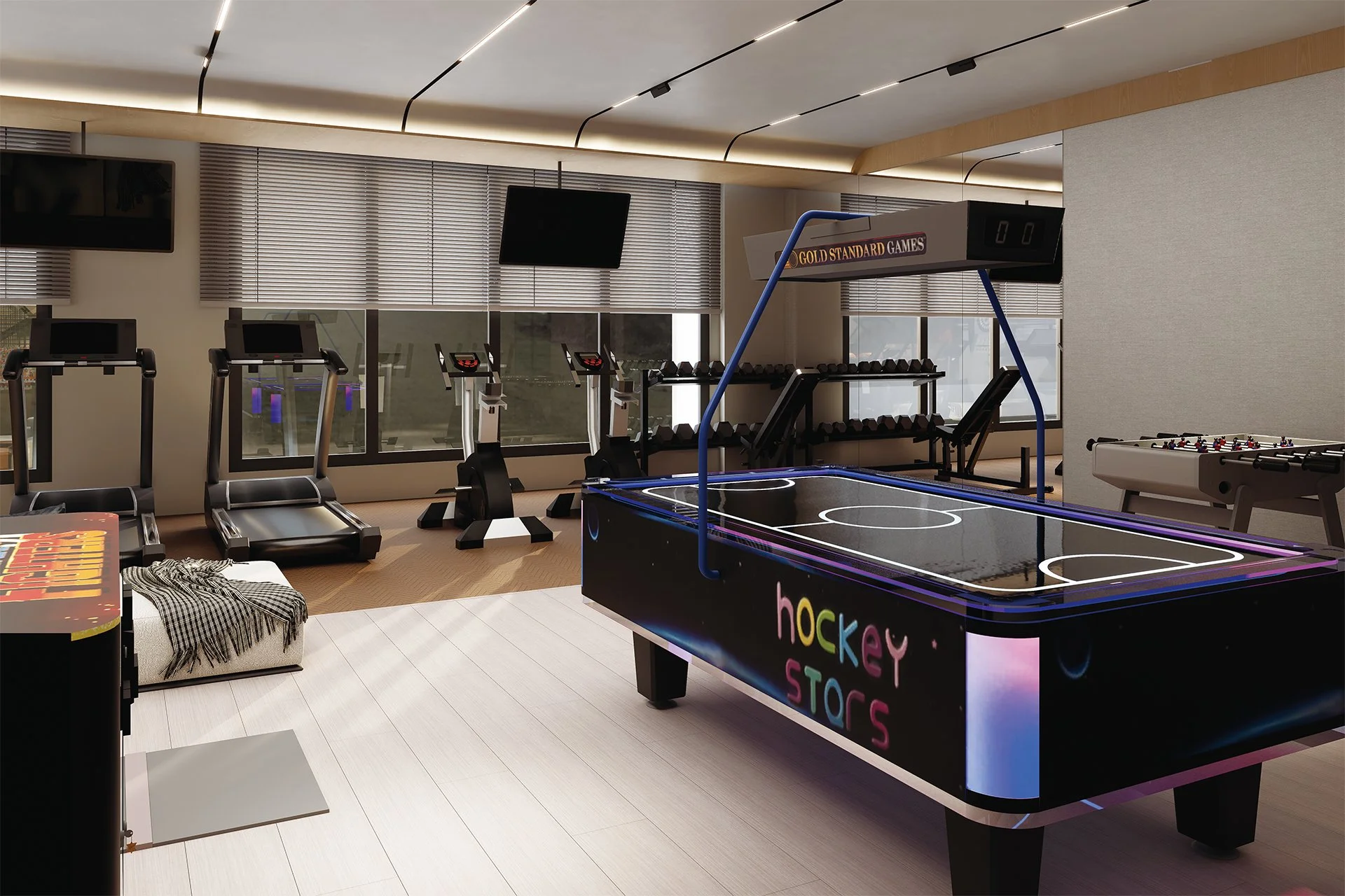 Indoor arcade room with hockey table, treadmill, stationary bikes, and a foosball table. Large window with blinds and two wall-mounted TV screens.