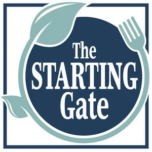 A logo with leaves and a fork, with the text "The Starting Gate" in the center.