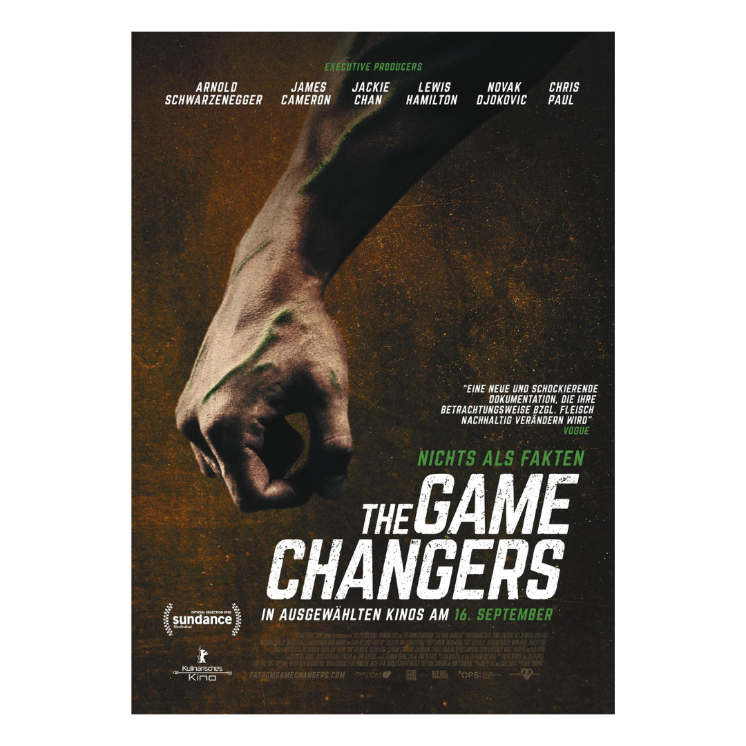 Poster for the documentary film "The Game Changers" featuring a close-up image of a muscular man's arm and hand with a clenched fist, with text listing the main producers, a quote, and the release date of September 16.