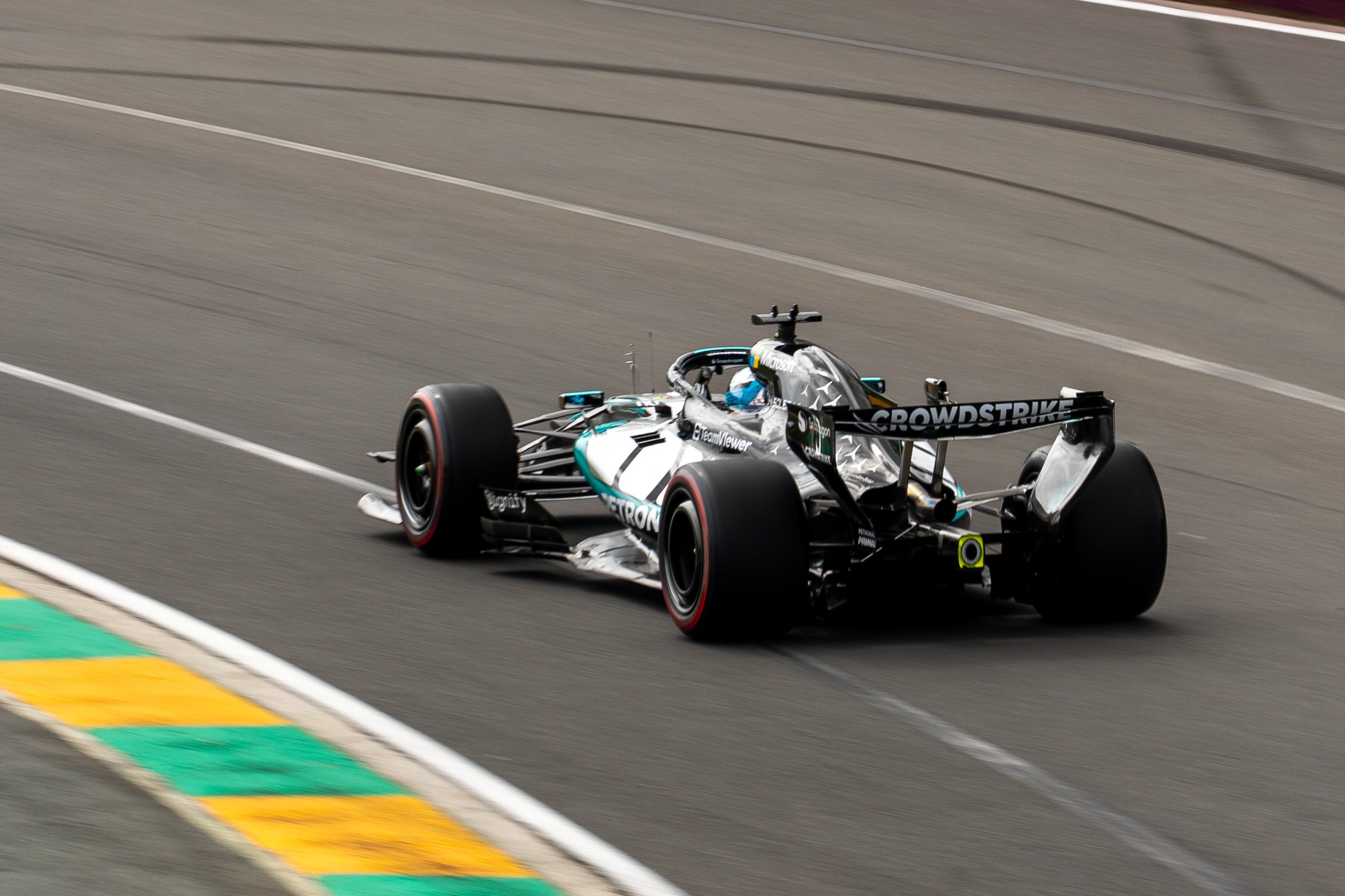A race car driving on a racetrack with colorful painted sections at the edge of the track. Mercedes Petronas Formula 1 Team George Russell Australian Grand Prix 2026 F1