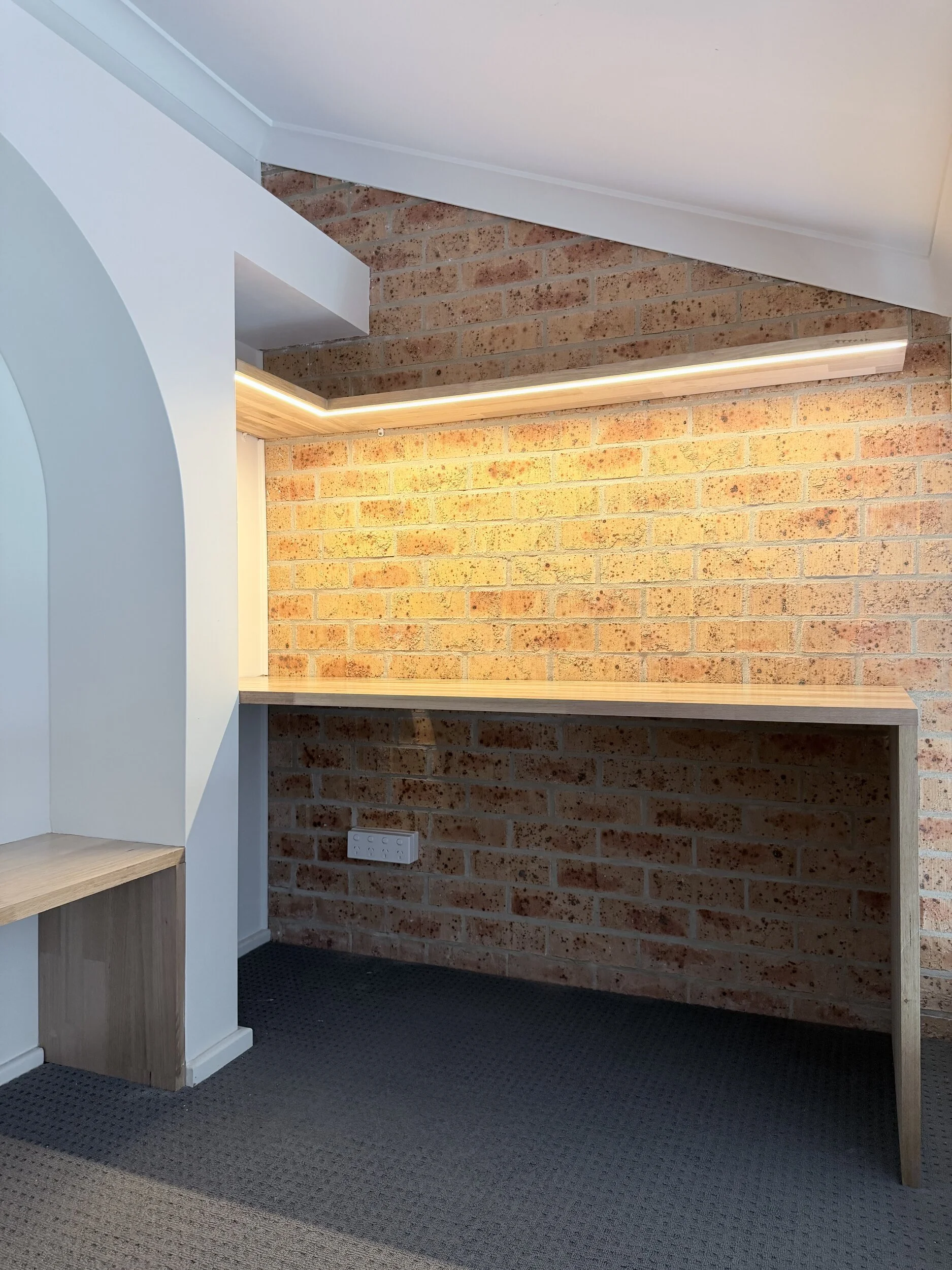 Custom study desk with LED-lit timber shelf in a Pelican loft, by Taf Carpentry & Joinery