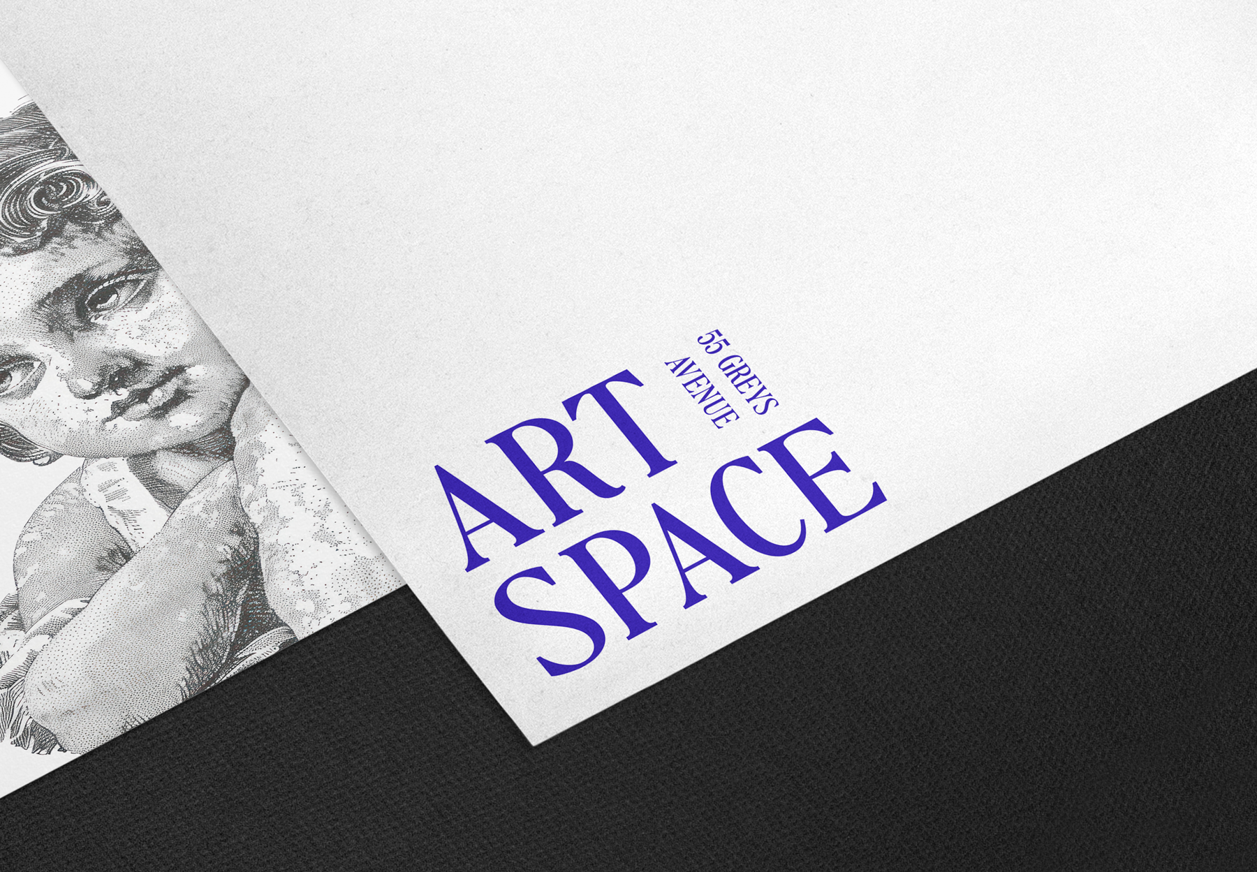 An exhibition style brochure titled "Art in Space" featuring the address 55 Greys Avenue. For shared work environment branding. A black and white illustration of a cherub is partially visible underneath the brochure.