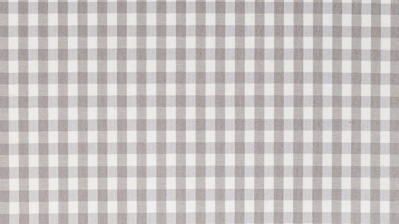 A checkered fabric tablecloth with a pattern of white and gray squares