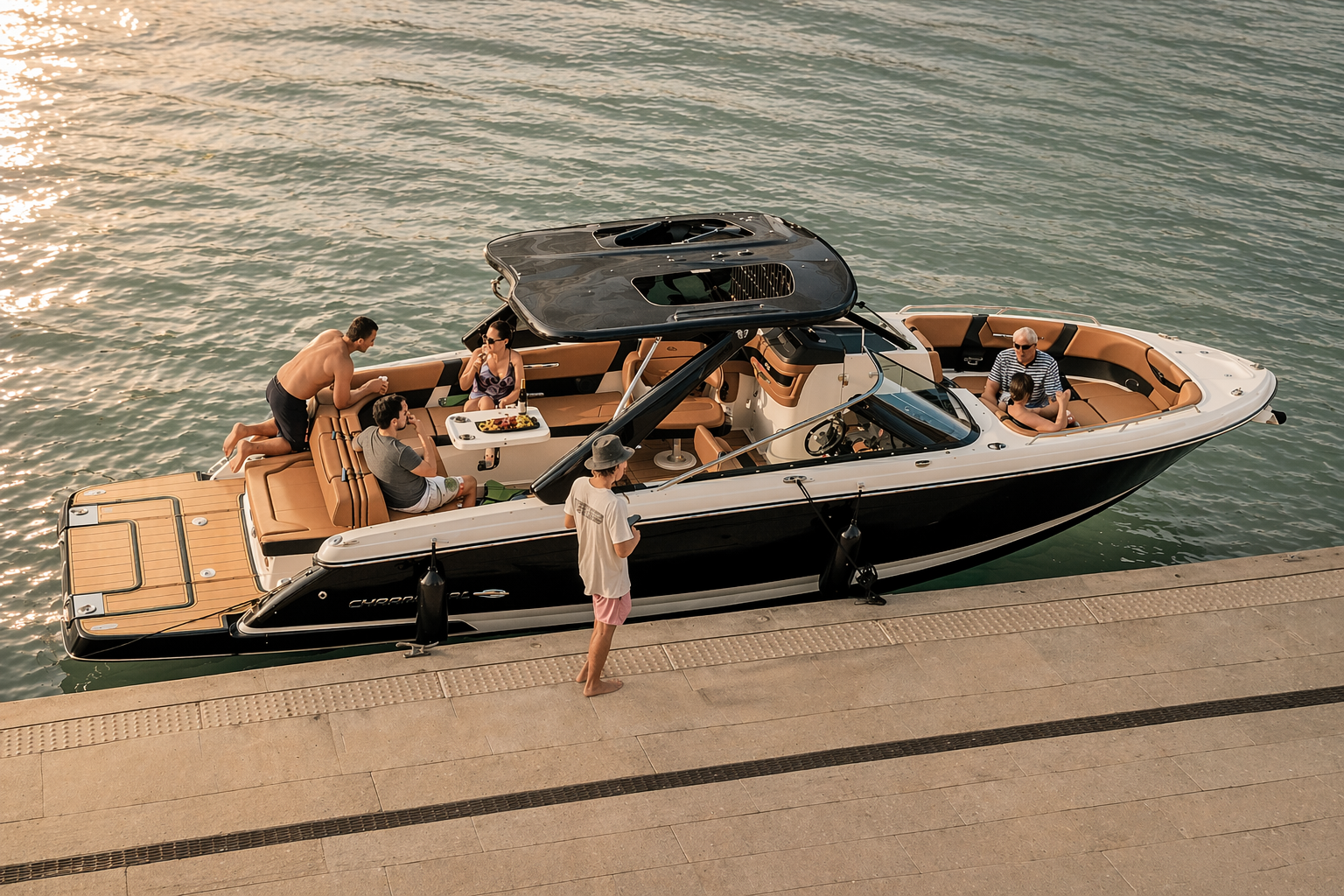 People on a black and white motorboat docked at a pier, with six adults and a child socializing and relaxing on the boat.