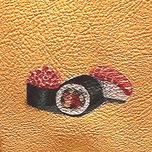 A roll of black and white tape with pink edges on textured orange background.