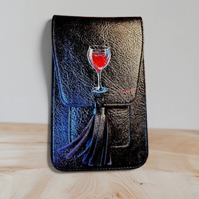 Black leather clutch with a colorful painted image of a glass of red wine and a napkin on the front.