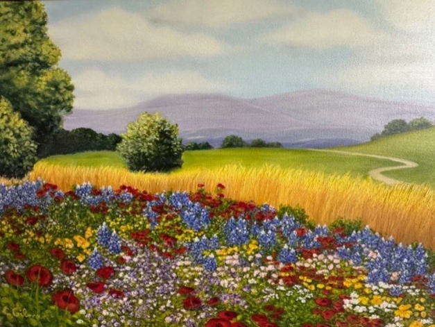 A colorful landscape painting of a countryside with a flower field in the foreground, a green field with trees in the middle ground, and mountains with a cloudy sky in the background.