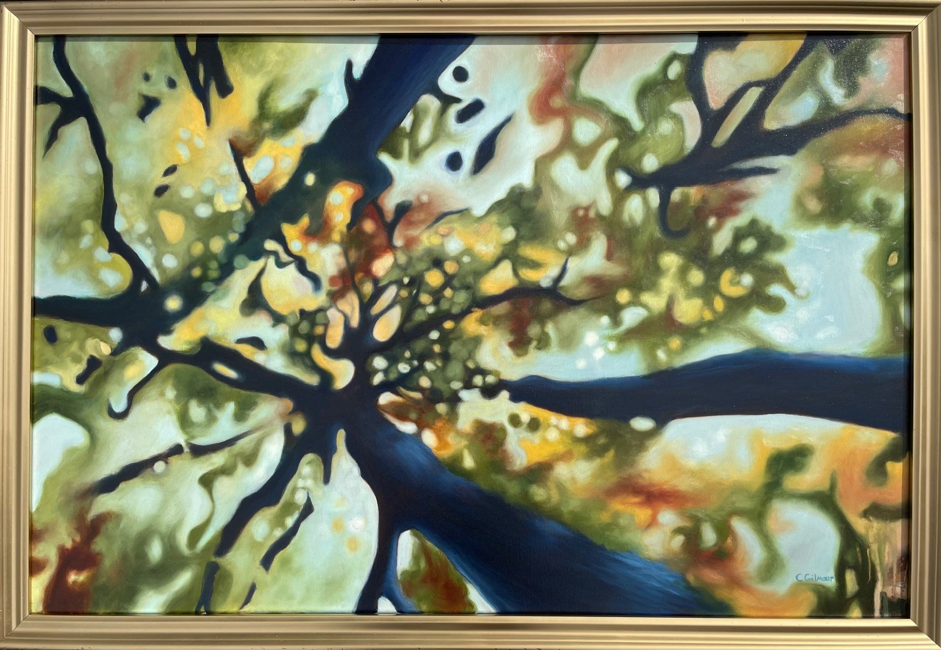 Abstract painting of a tree with dark branches against a colorful background with shades of yellow, green, and reddish hues.
