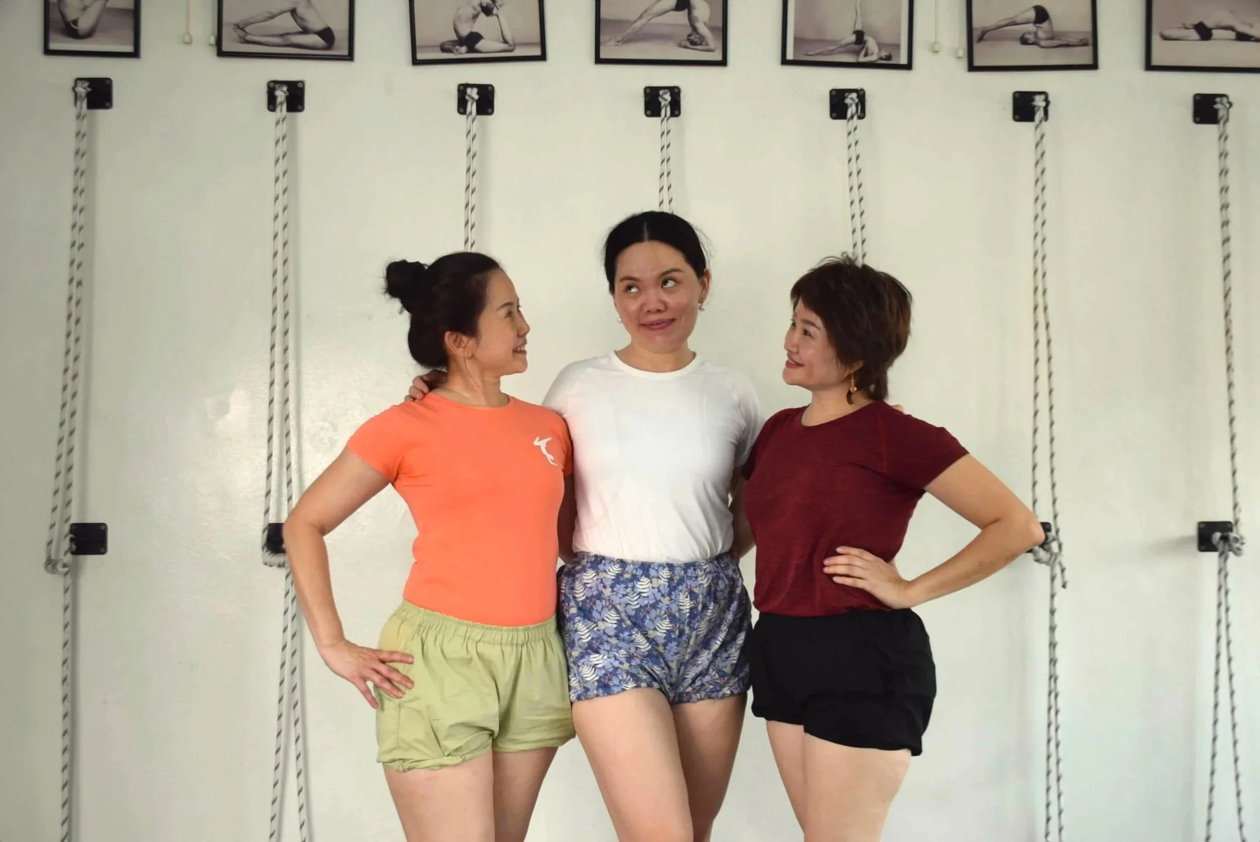 Simple Life Yoga Kepong teachers smiling at each other in their yoga studio