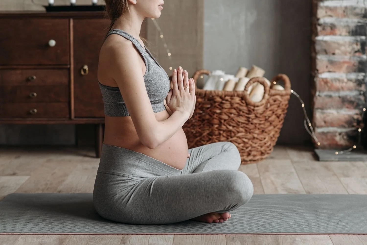 A pregnant women practicing yoga on a yoga mat