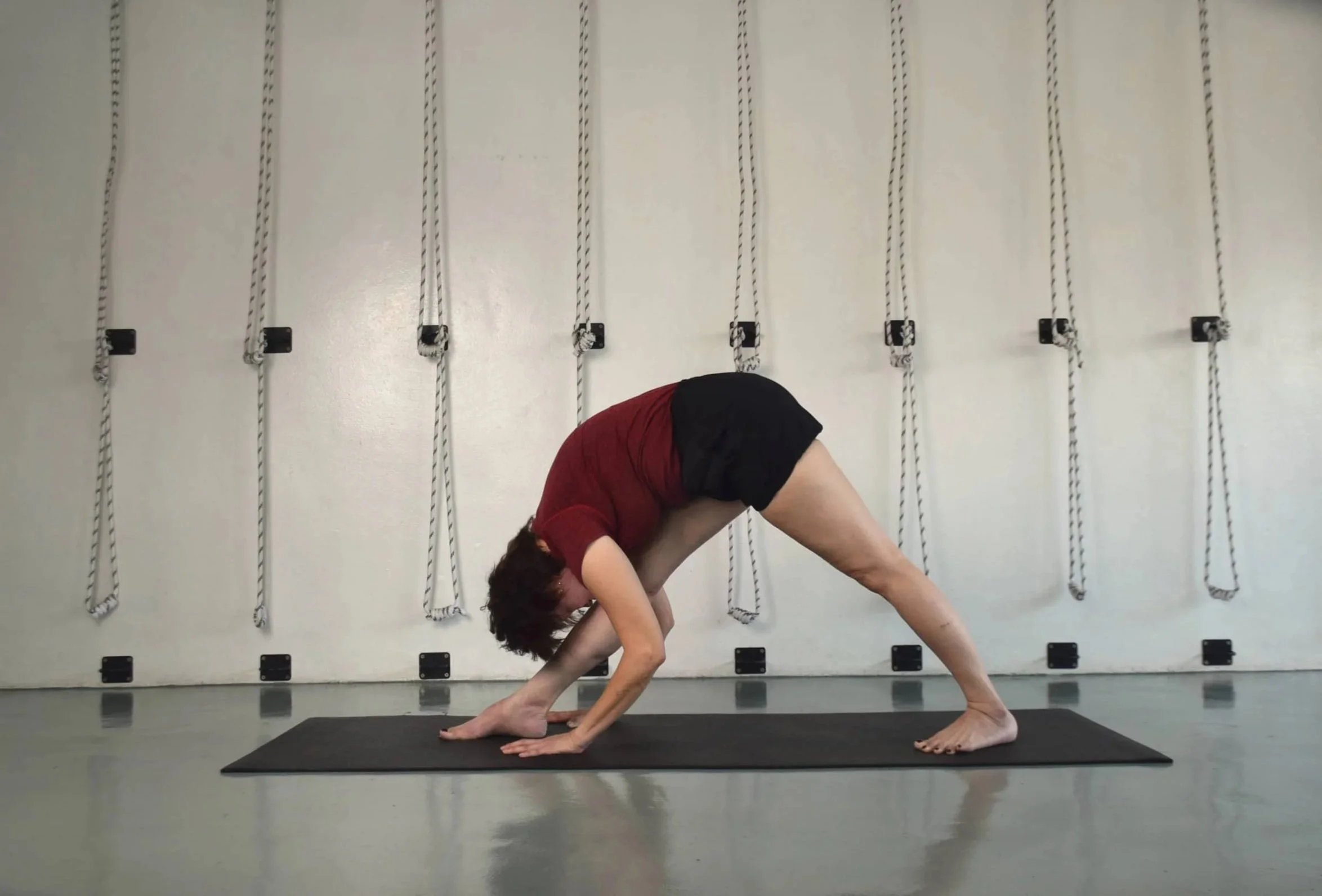 Yoga teacher demonstrating yoga poses in a Kepong yoga studio