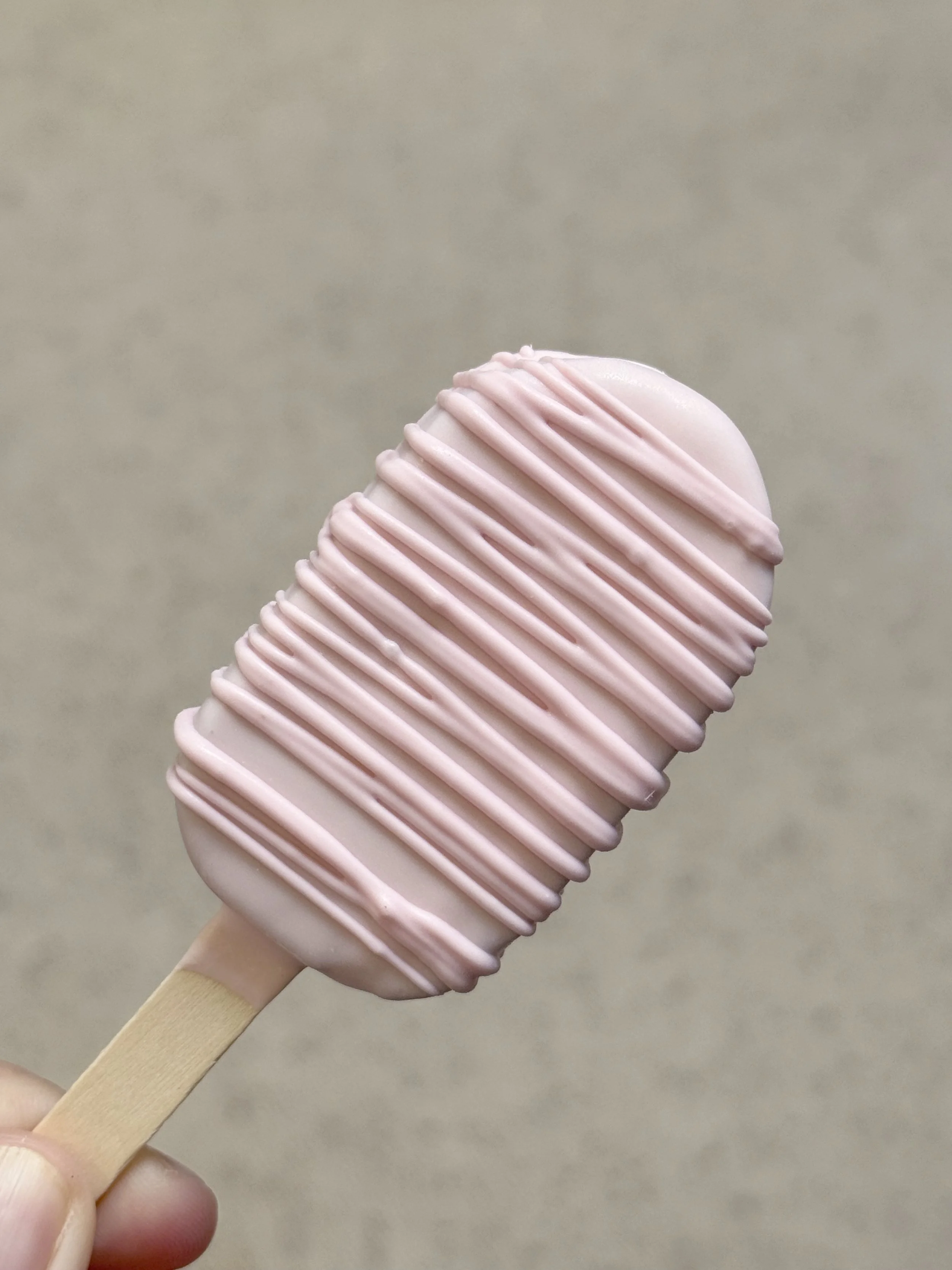 light pink cake pop with pink drizzle
