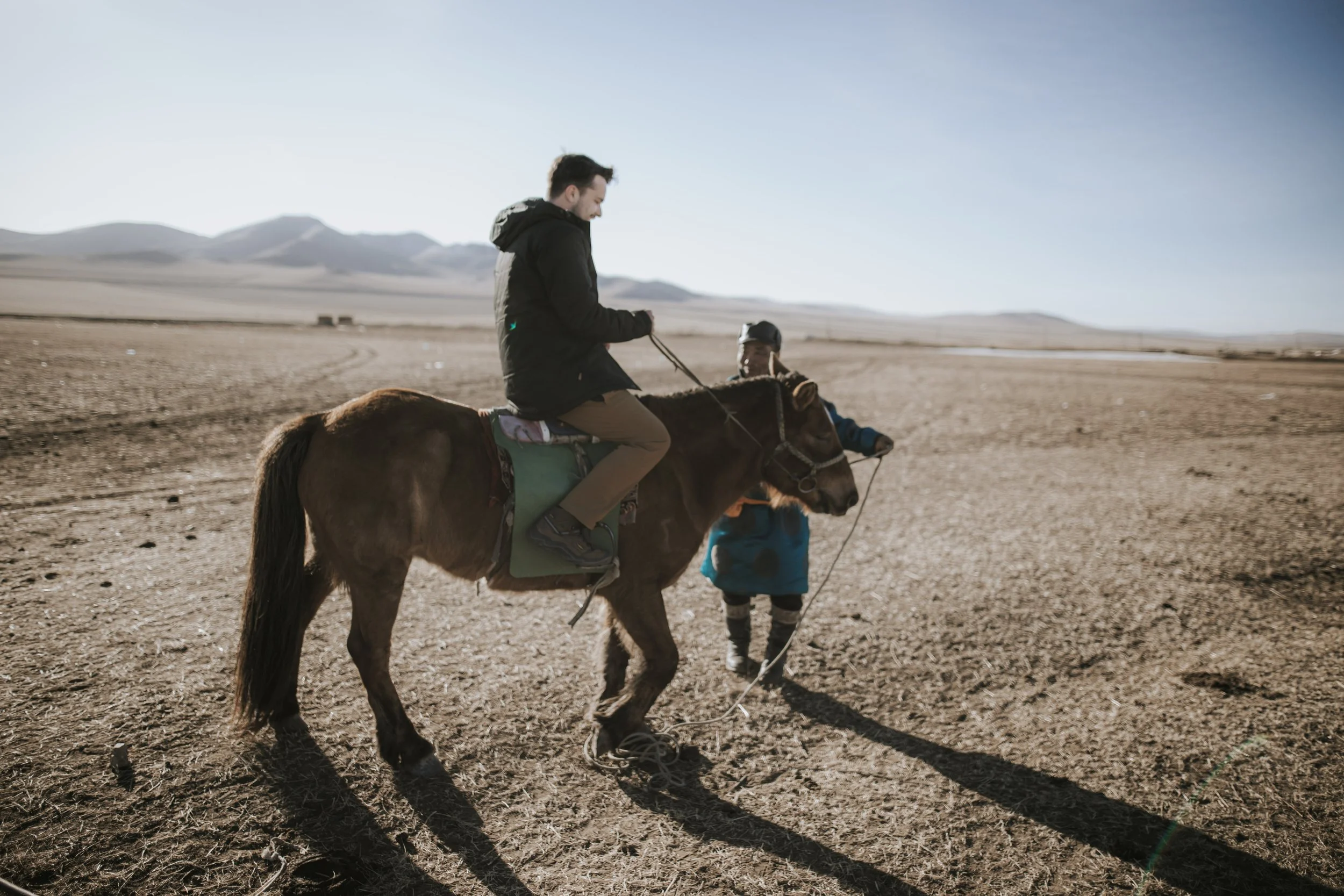 Grayson Zaragoza on horseback during a remote international expedition, documenting global storytelling and production work
