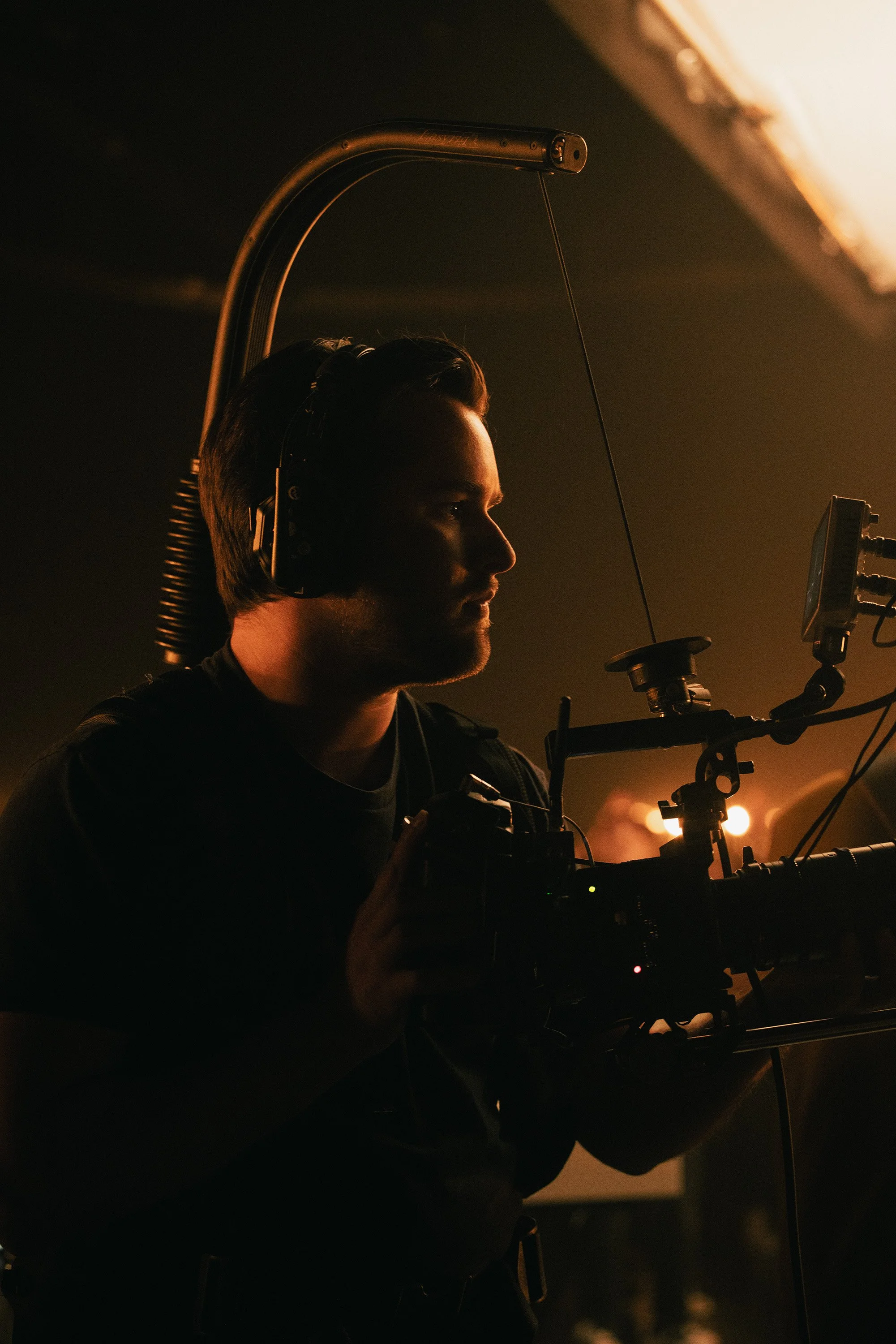 Grayson Zaragoza, founder of North Sky Productions, operating professional cinema camera during low-light video production shoot