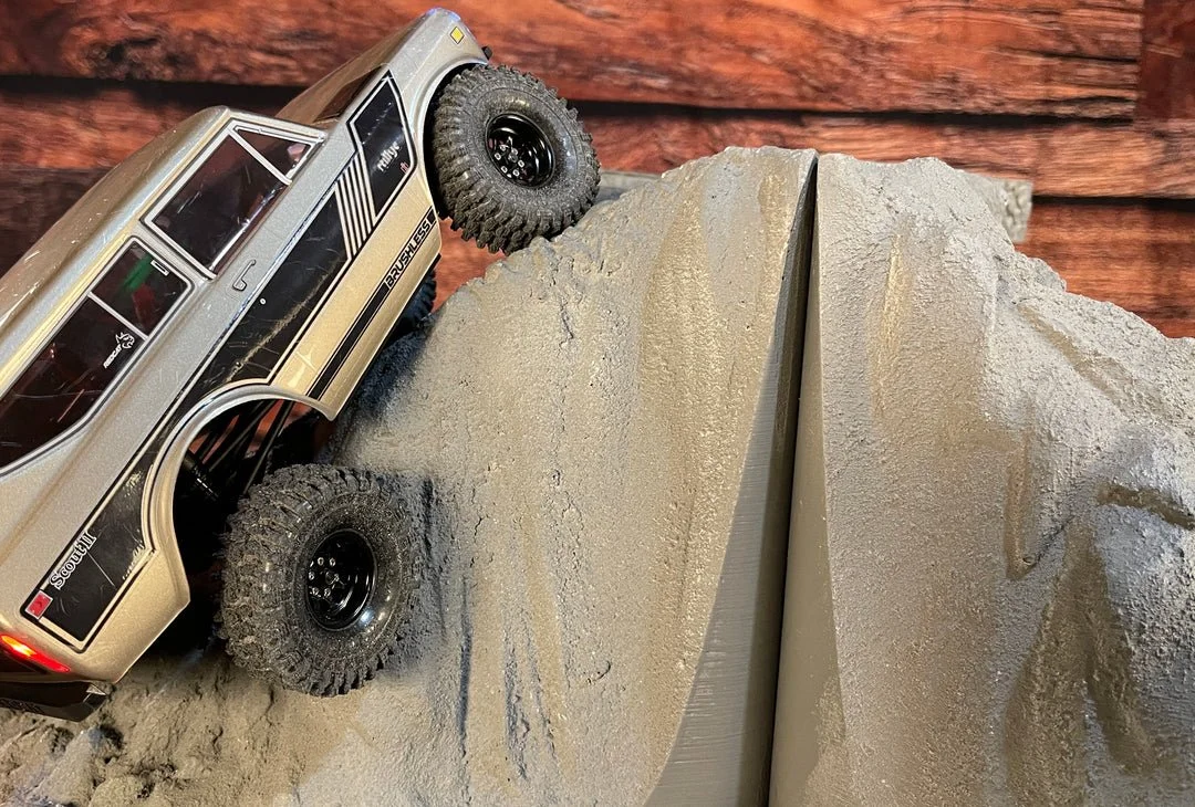 A RedCat Ascent Scout II Remote Controlled Crawler climbing a steep MountainBlox sand-dune slope.
